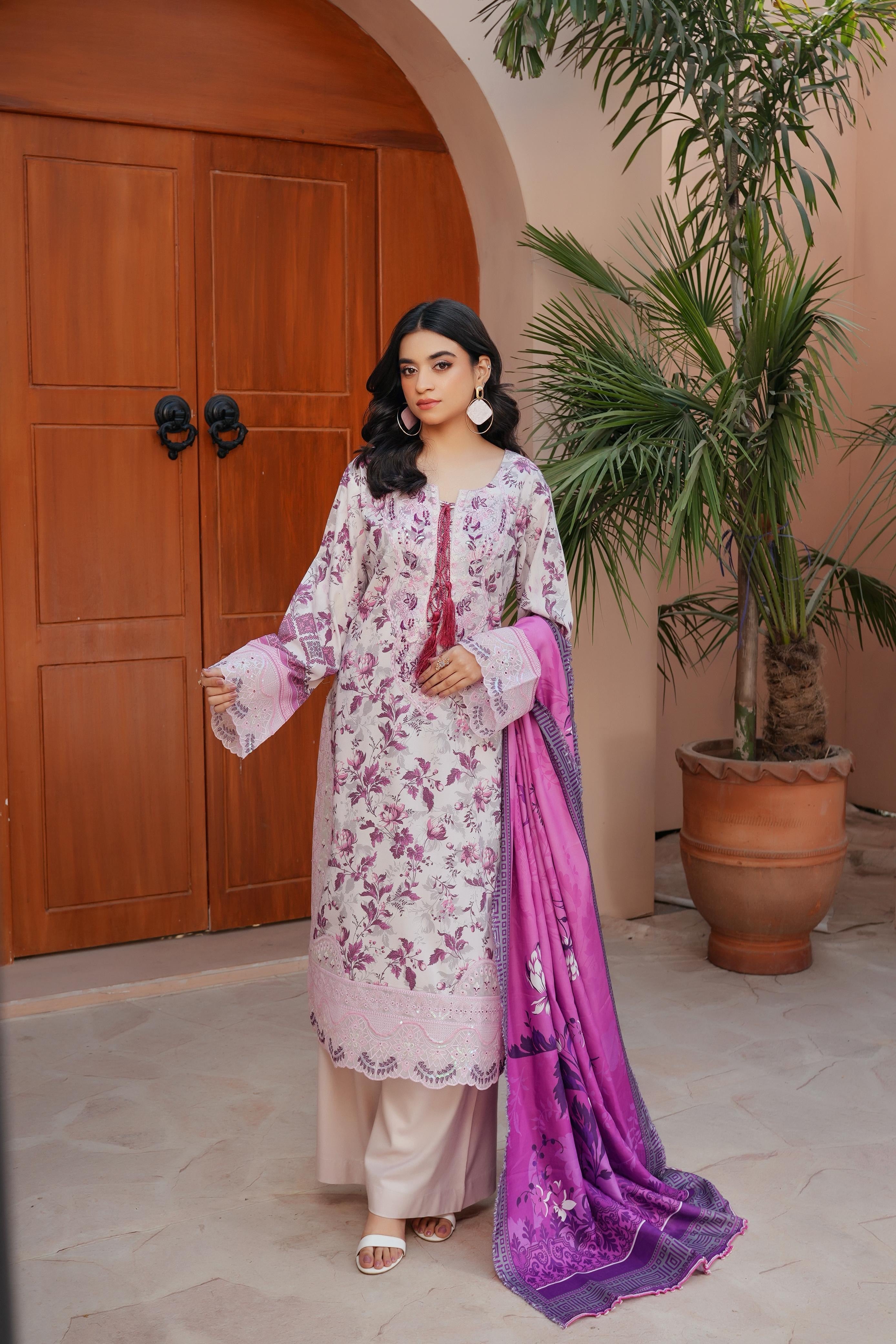 Traditional Pakistani Salwar Kameez for women, colorful cultural wear by Saree Ghor Charlotte, featuring intricate embroidery and vibrant fabric.