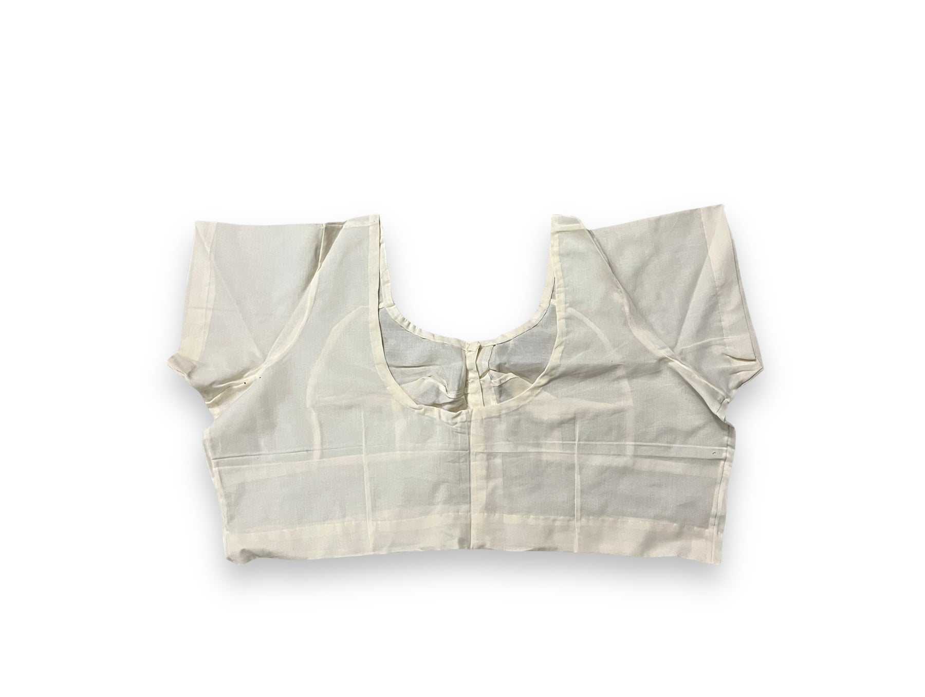 Cream-colored traditional ready-made blouse for saree by Saree Ghor Charlotte, featuring ethnic design and intricate stitching.