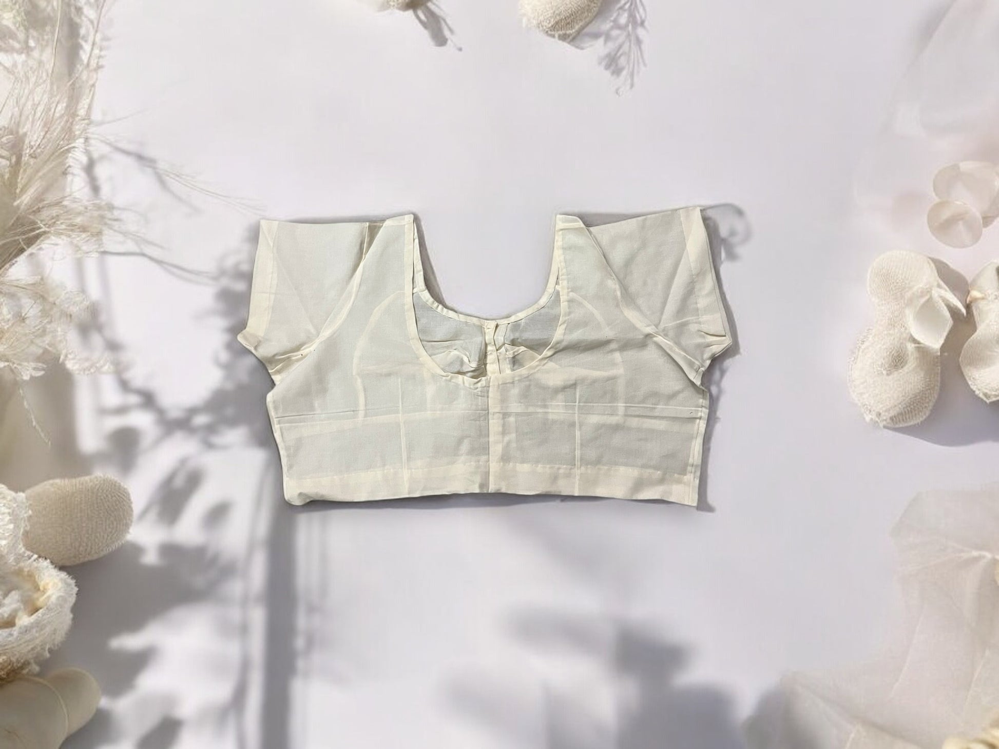 Cream-colored traditional ready-made blouse for saree by Saree Ghor Charlotte, featuring ethnic design and elegant fit for women.