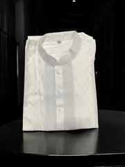 White cotton boys kurta from Saree Ghor Charlotte featuring a classic design, traditional cultural wear for young boys.