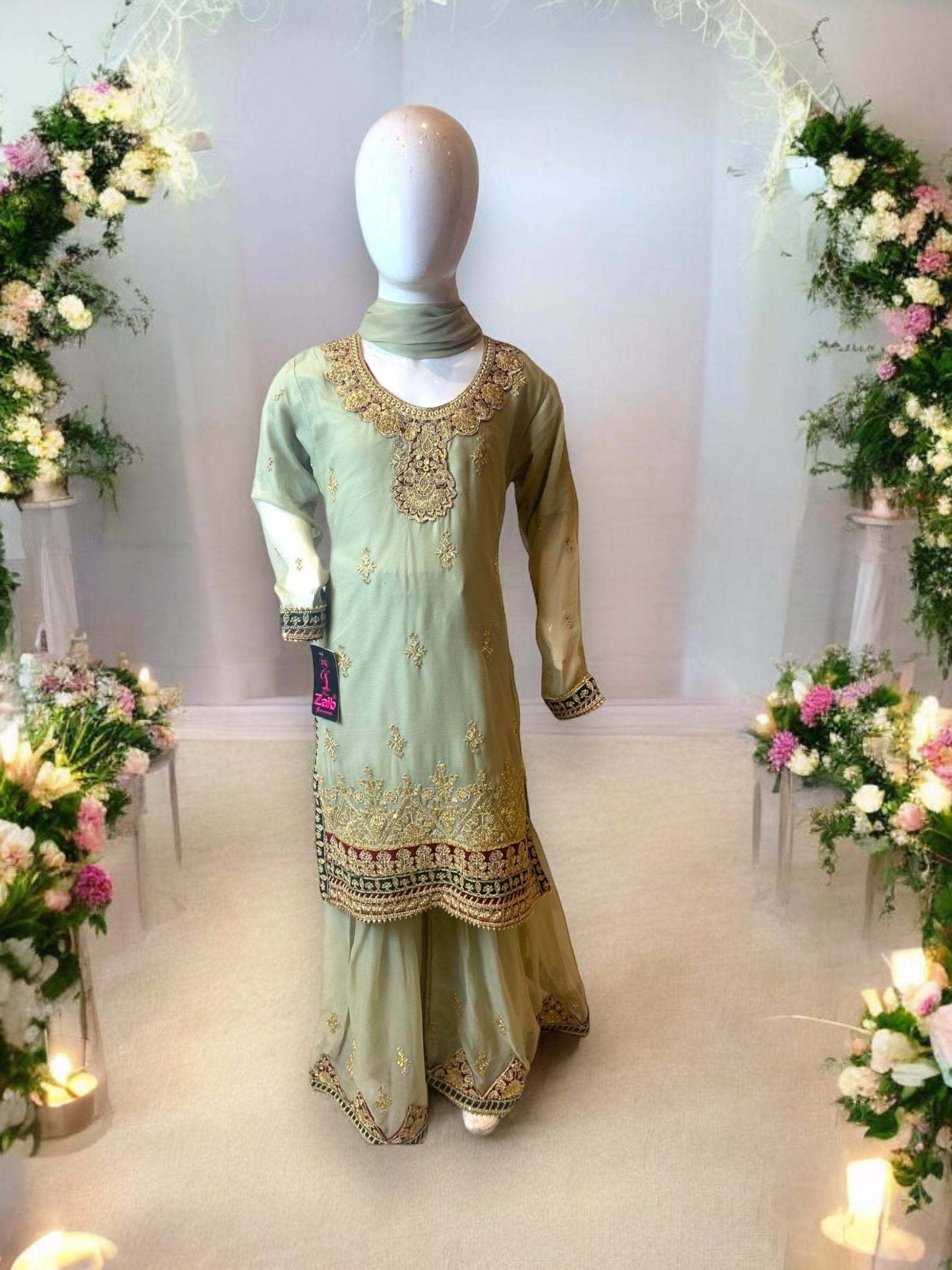 Little girl wearing a stylish designer Salwar Kameez by Saree Ghor Charlotte, featuring elegant ethnic wear for ages 6-12 months.