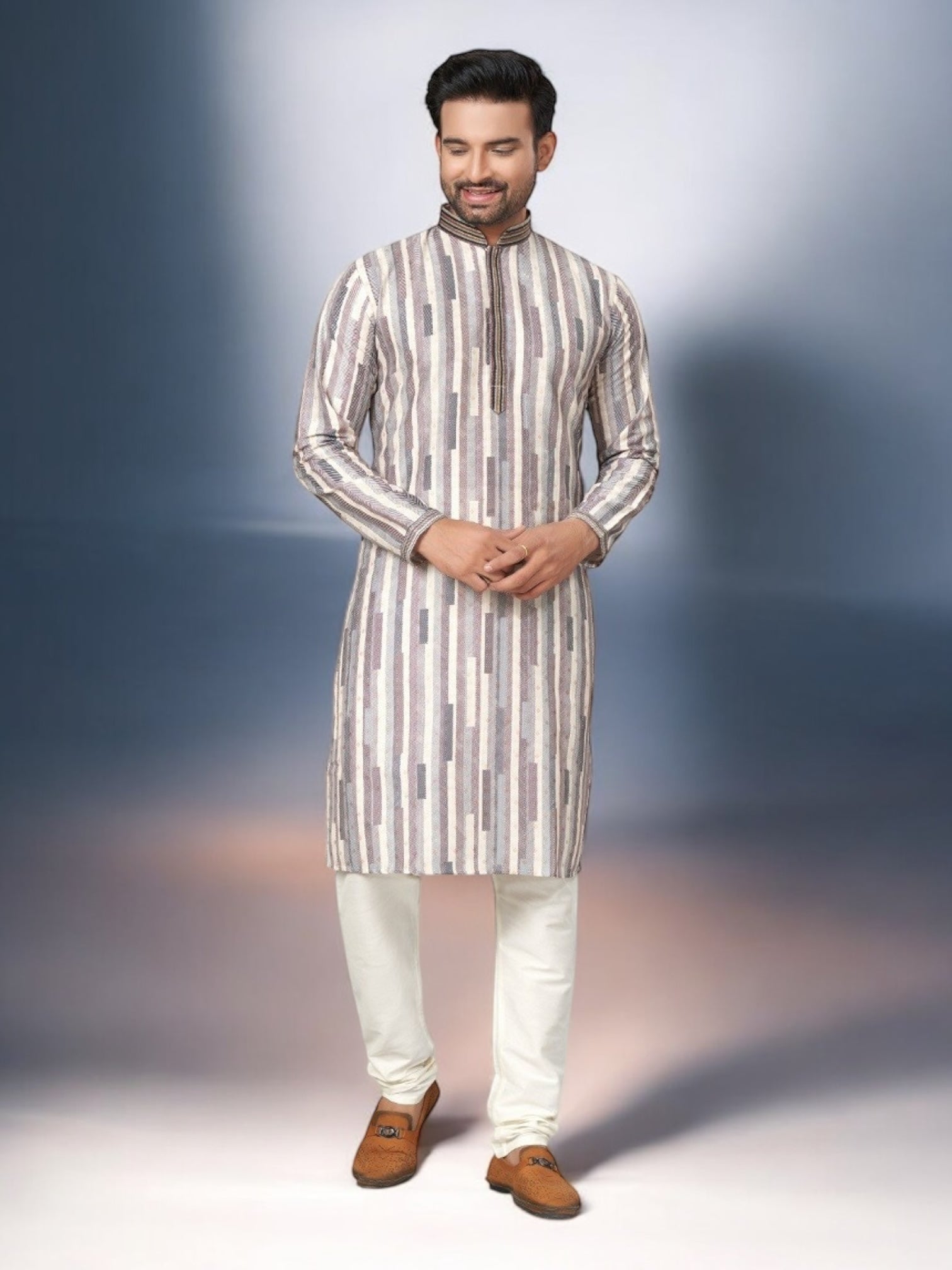 Traditional men's kurta pajama set by Saree Ghor Charlotte, featuring a white kurta with intricate embroidery and matching pajama.