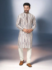 Traditional men's kurta pajama set by Saree Ghor Charlotte, featuring a white kurta with intricate embroidery and matching pajama.