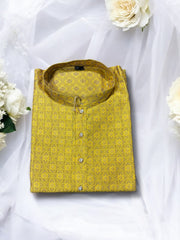 Traditional men's yellow silk kurta by Saree Ghor Charlotte, showcasing intricate ethnic wear design for cultural occasions.