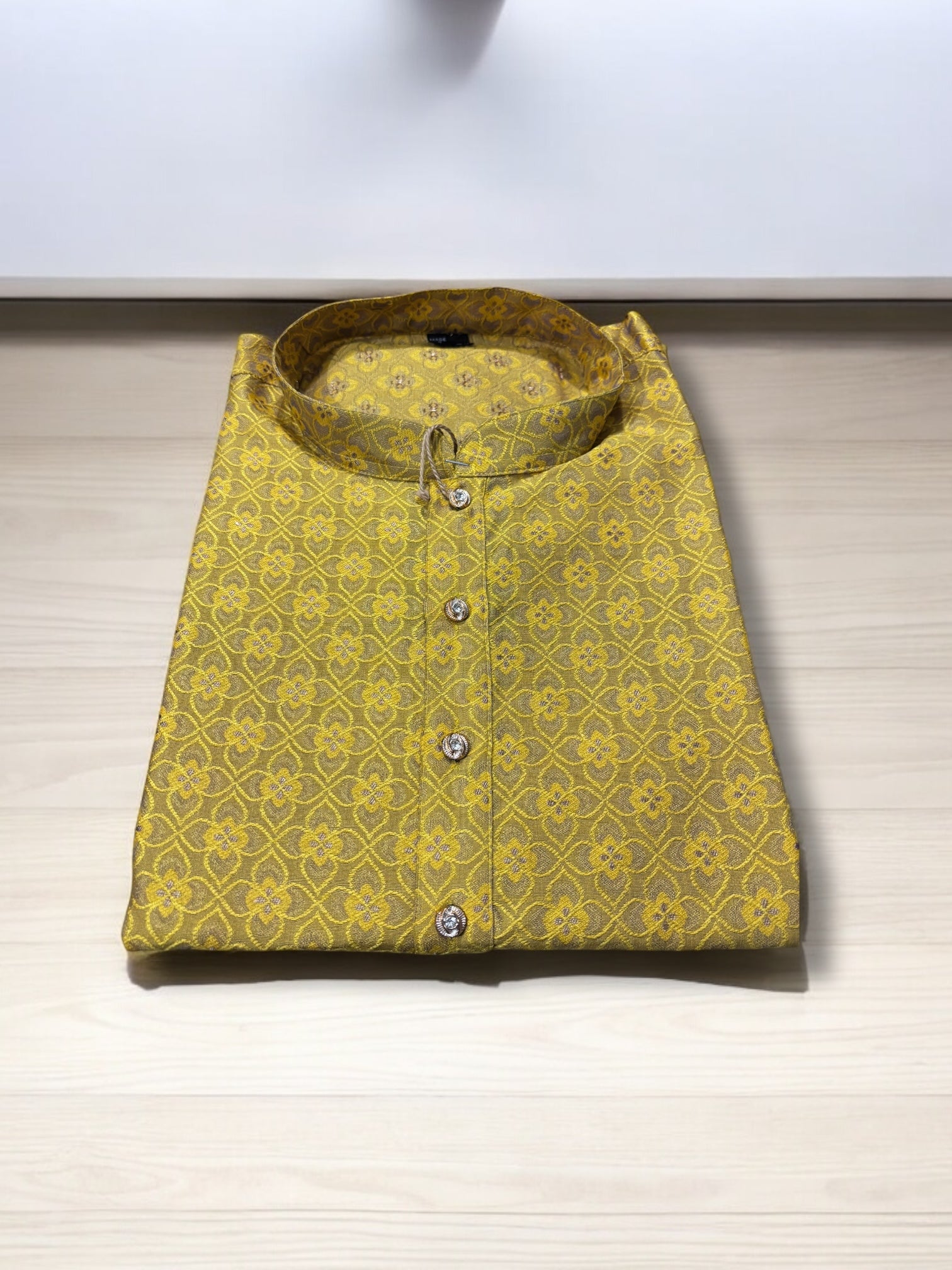 Traditional men's yellow silk kurta from Saree Ghor Charlotte, showcasing ethnic wear with intricate design and fabric details.
