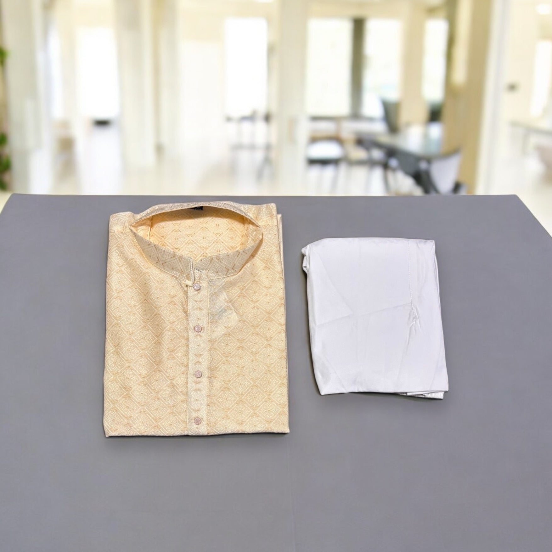Men's cream silk kurta and pajama set by Saree Ghor Charlotte, traditional Indian attire with intricate design details.