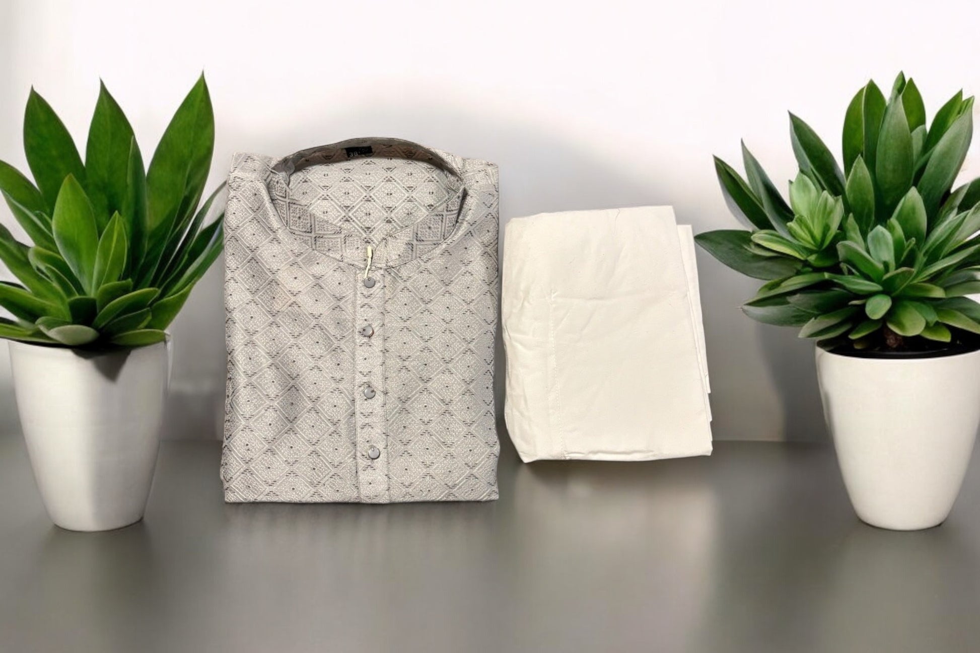 Men's traditional gray silk kurta and pajama from Saree Ghor Charlotte, showcasing elegant fabric and classic design.