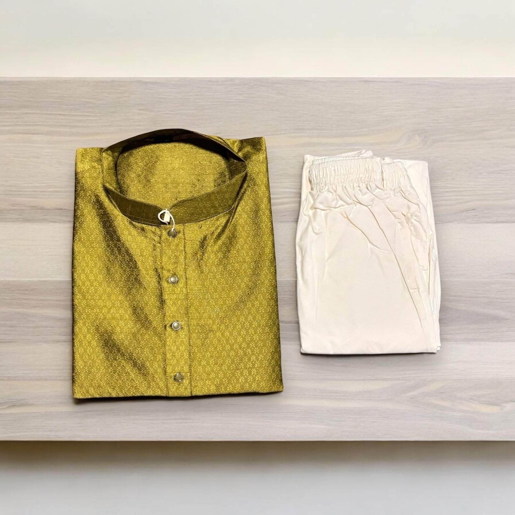 Men's traditional green silk kurta with matching pajama from Saree Ghor Charlotte, featuring intricate design and elegant fit.