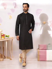 Black cotton men's kurta with matching pajama set by Saree Ghor Charlotte, traditional ethnic wear for men.