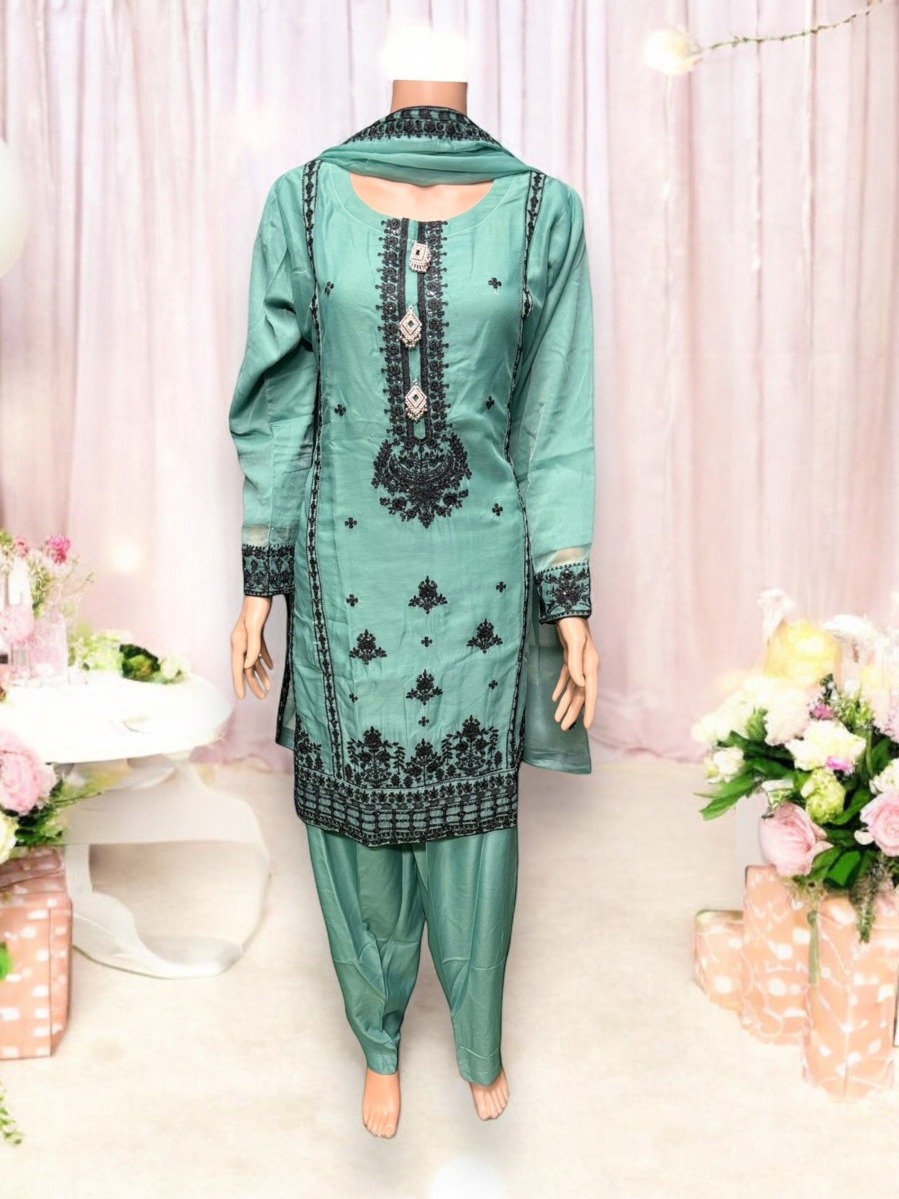 Designer party wear Salwar Kameez set by Saree Ghor Charlotte, featuring vibrant ethnic fabric and intricate embroidery for women.