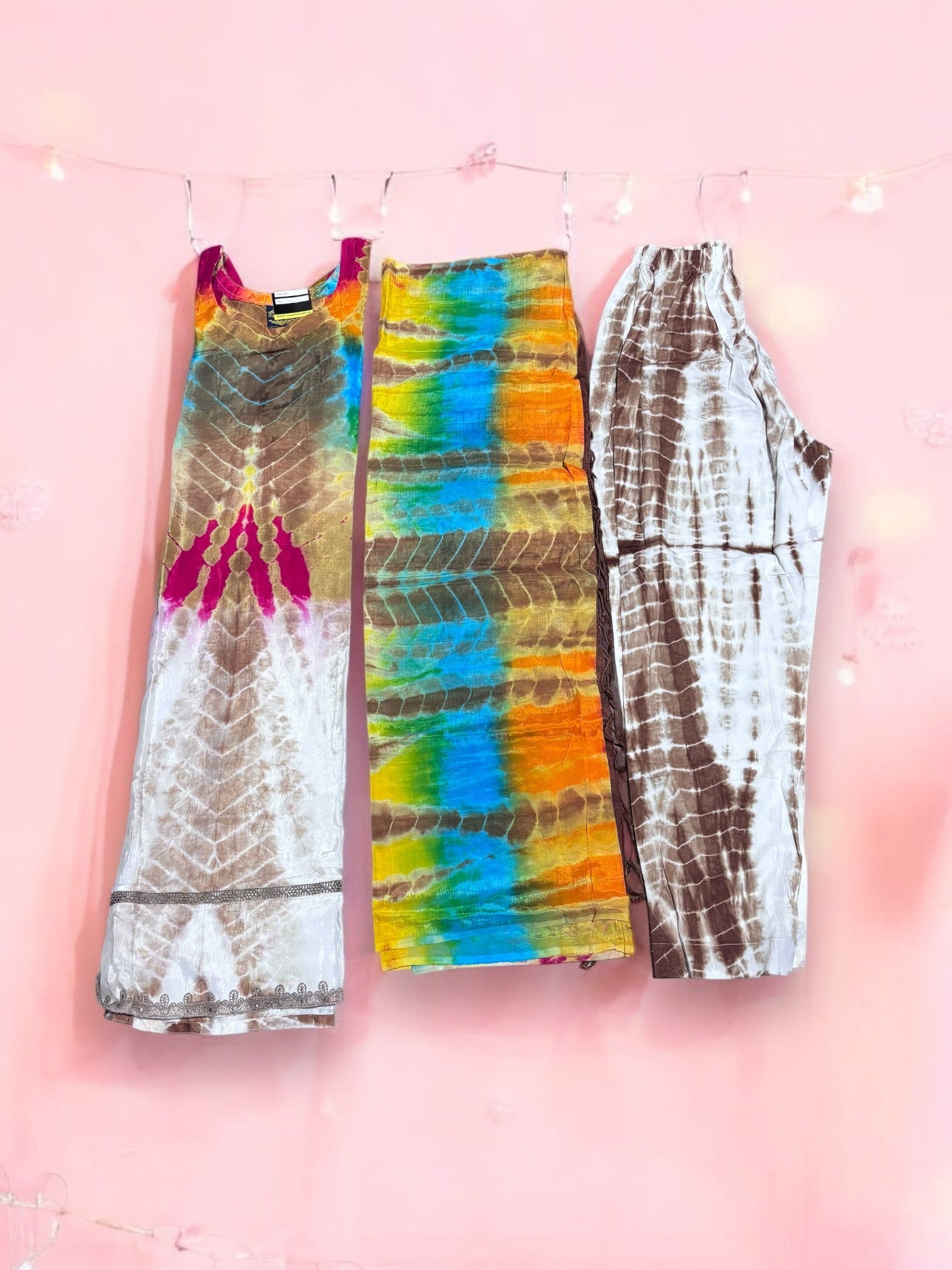 Traditional silk salwar kameez set by Saree Ghor Charlotte, featuring intricate designs and vibrant colors, displayed on a mannequin.
