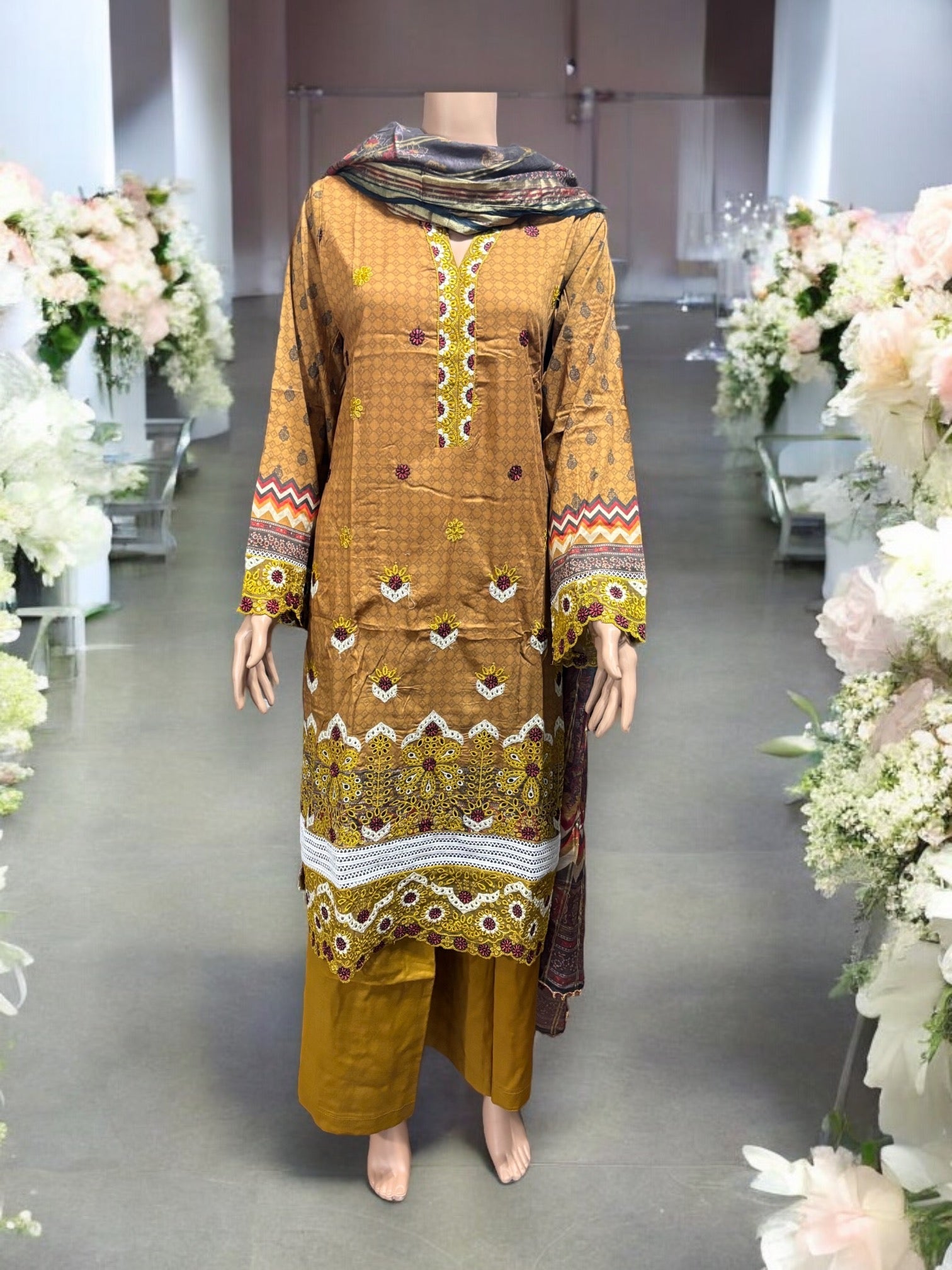 Pakistani traditional Salwar Kameez set by Saree Ghor Charlotte, featuring intricate embroidery and vibrant ethnic wear for women.