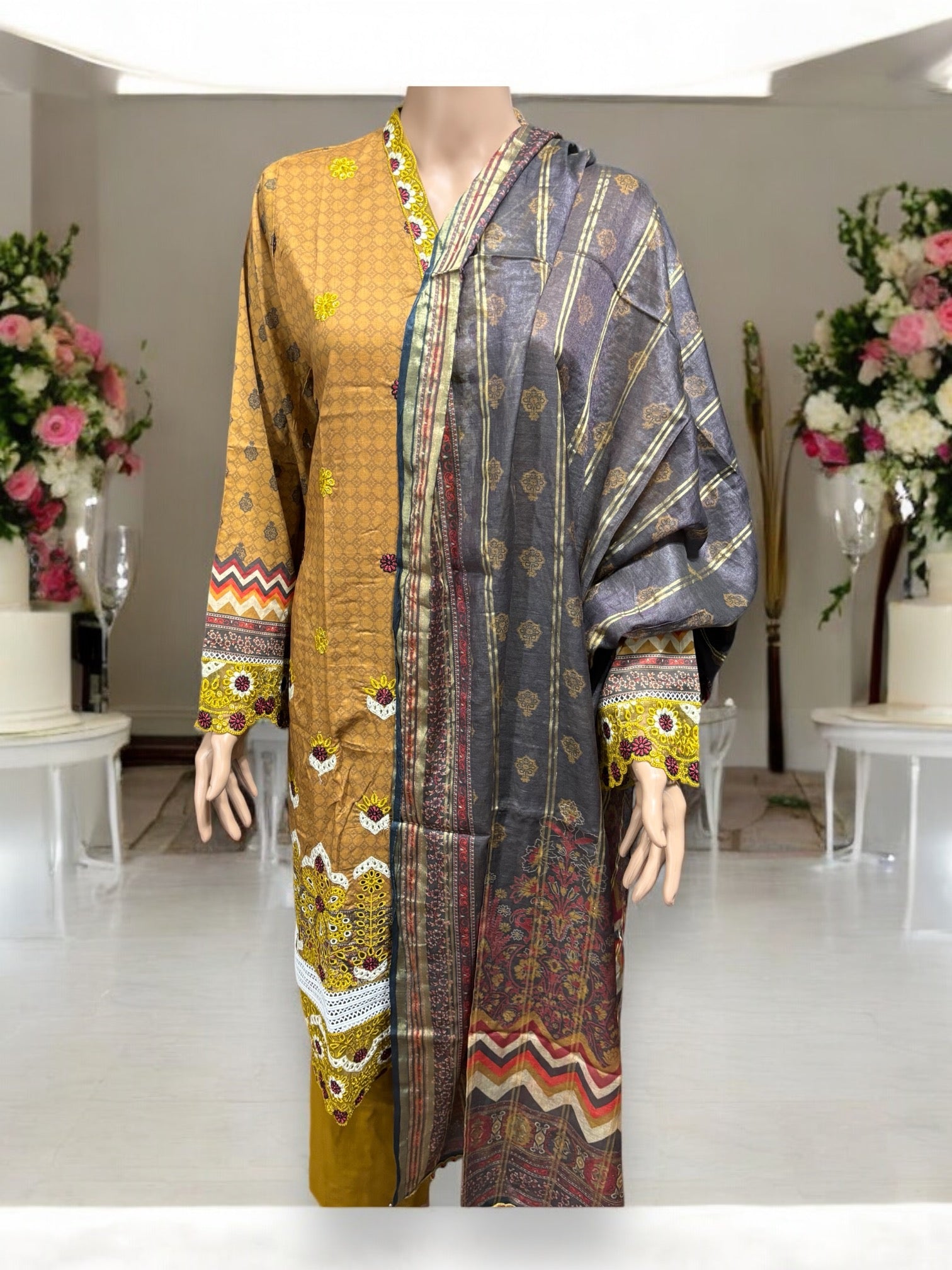 Pakistani traditional Salwar Kameez set by Saree Ghor Charlotte, featuring intricate embroidery and vibrant ethnic design for women.