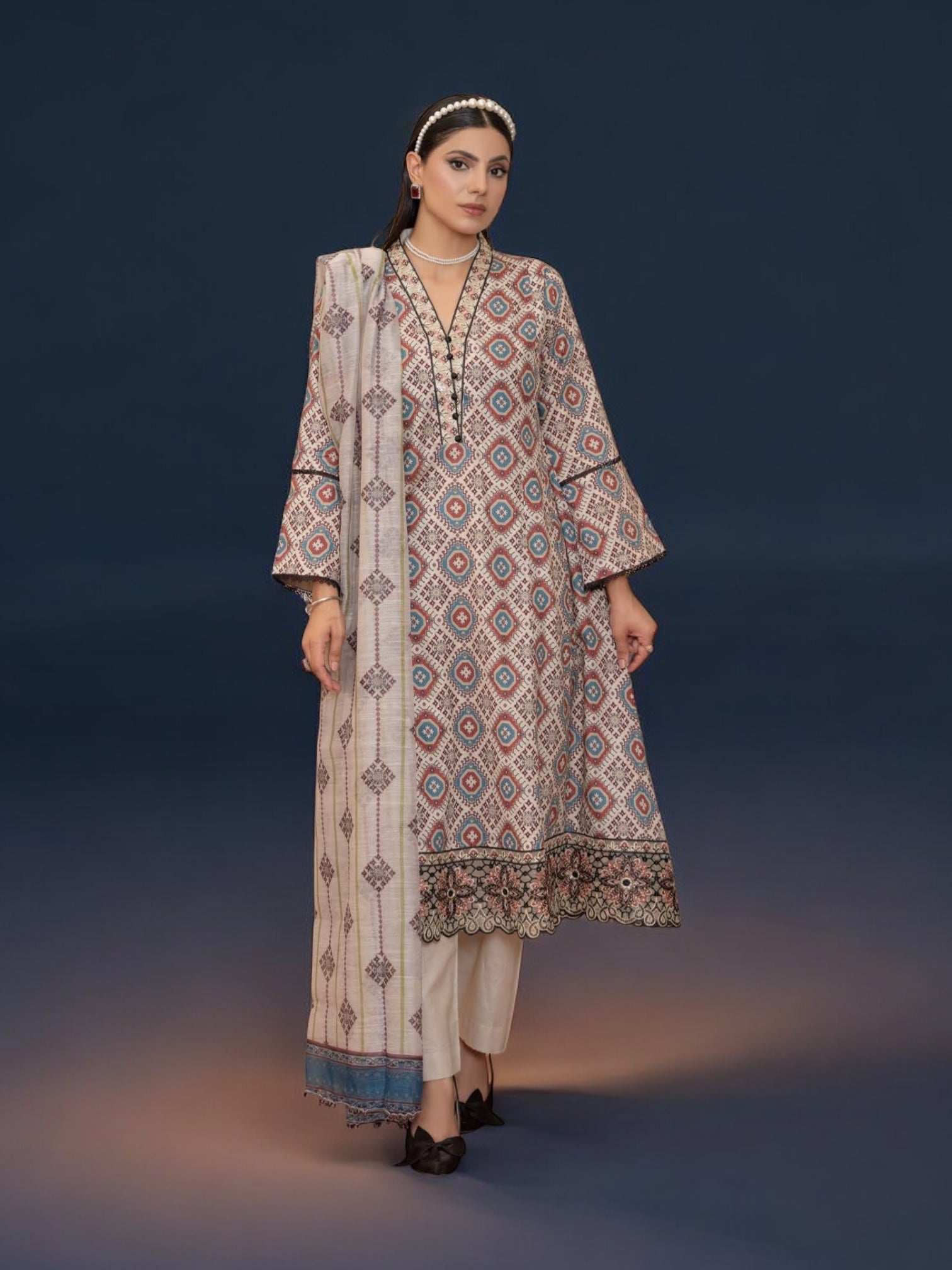 Pakistani Salwar Kameez suit by Saree Ghor Charlotte featuring traditional ethnic wear for women, with intricate embroidery and vibrant colors.