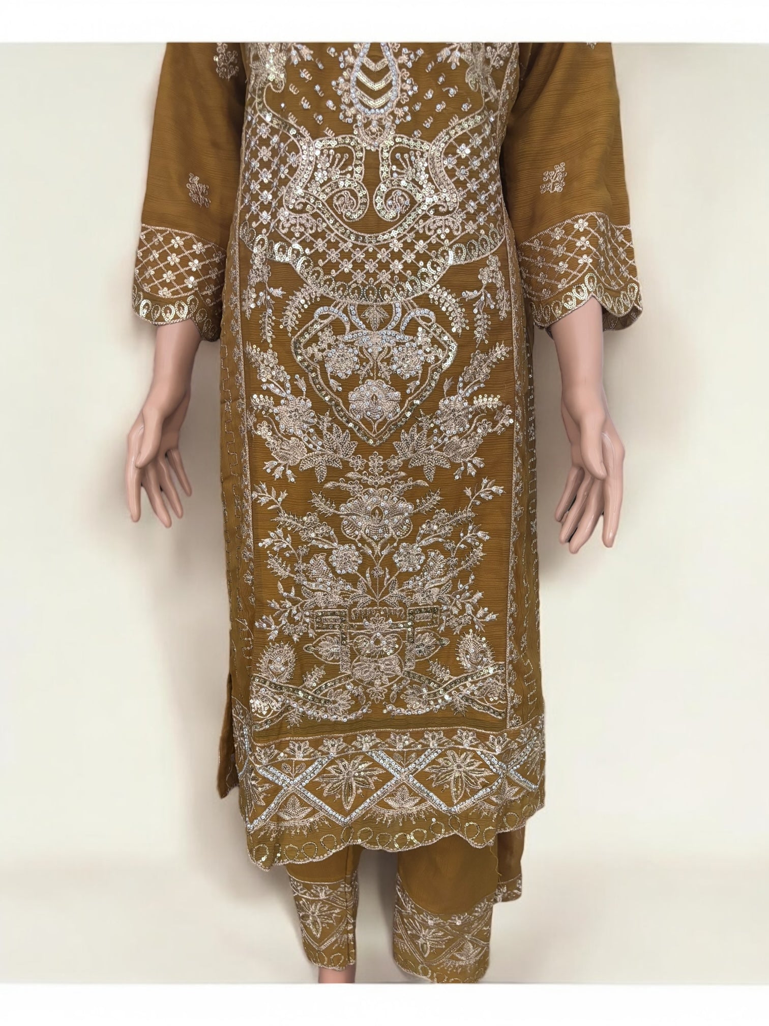 Traditional designer Salwar Kameez suit by Saree Ghor Charlotte, elegant ethnic wear for women with intricate patterns.