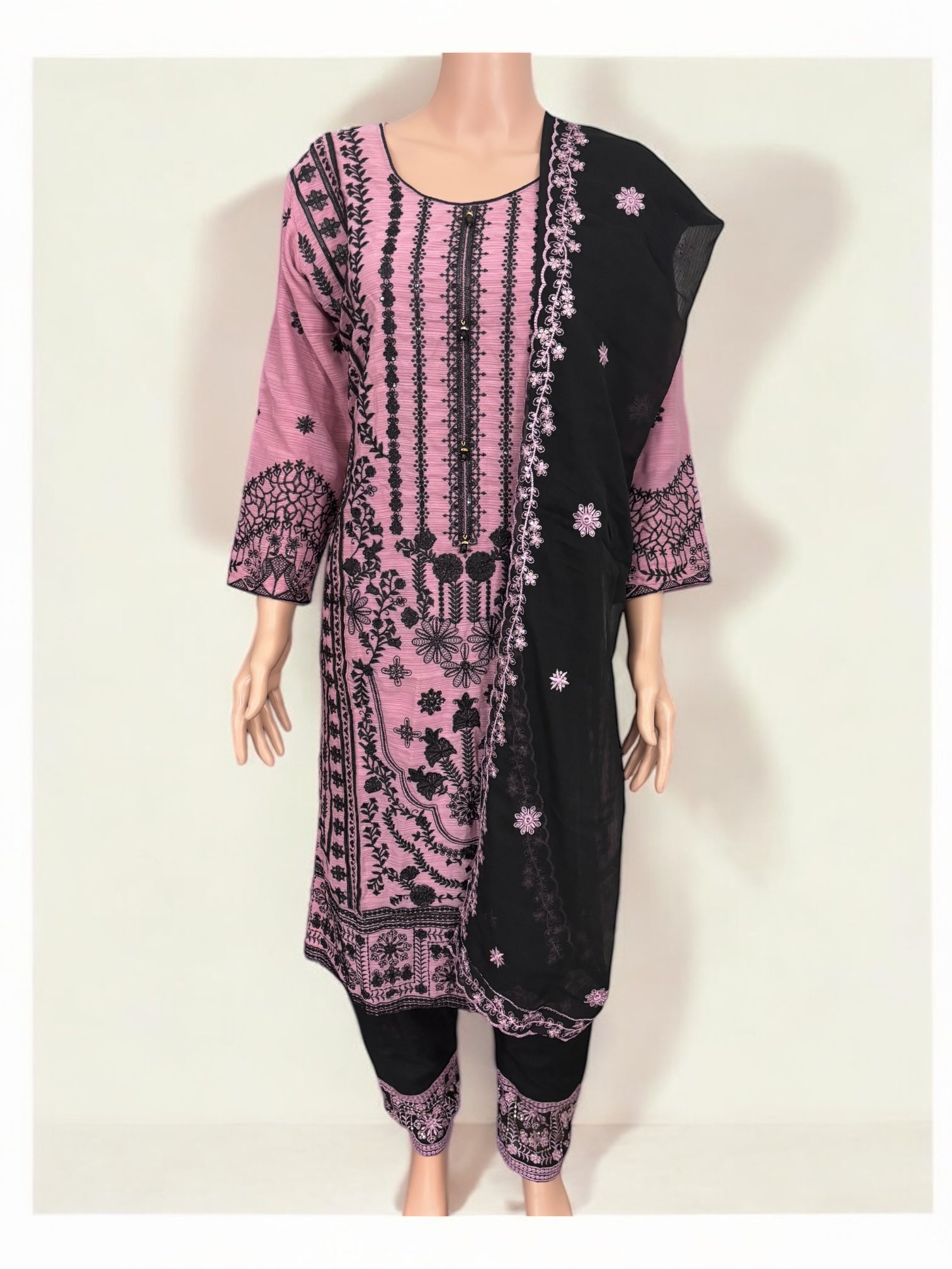 Traditional designer Salwar Kameez suit by Saree Ghor Charlotte featuring intricate ethnic embroidery and vibrant fabric details.