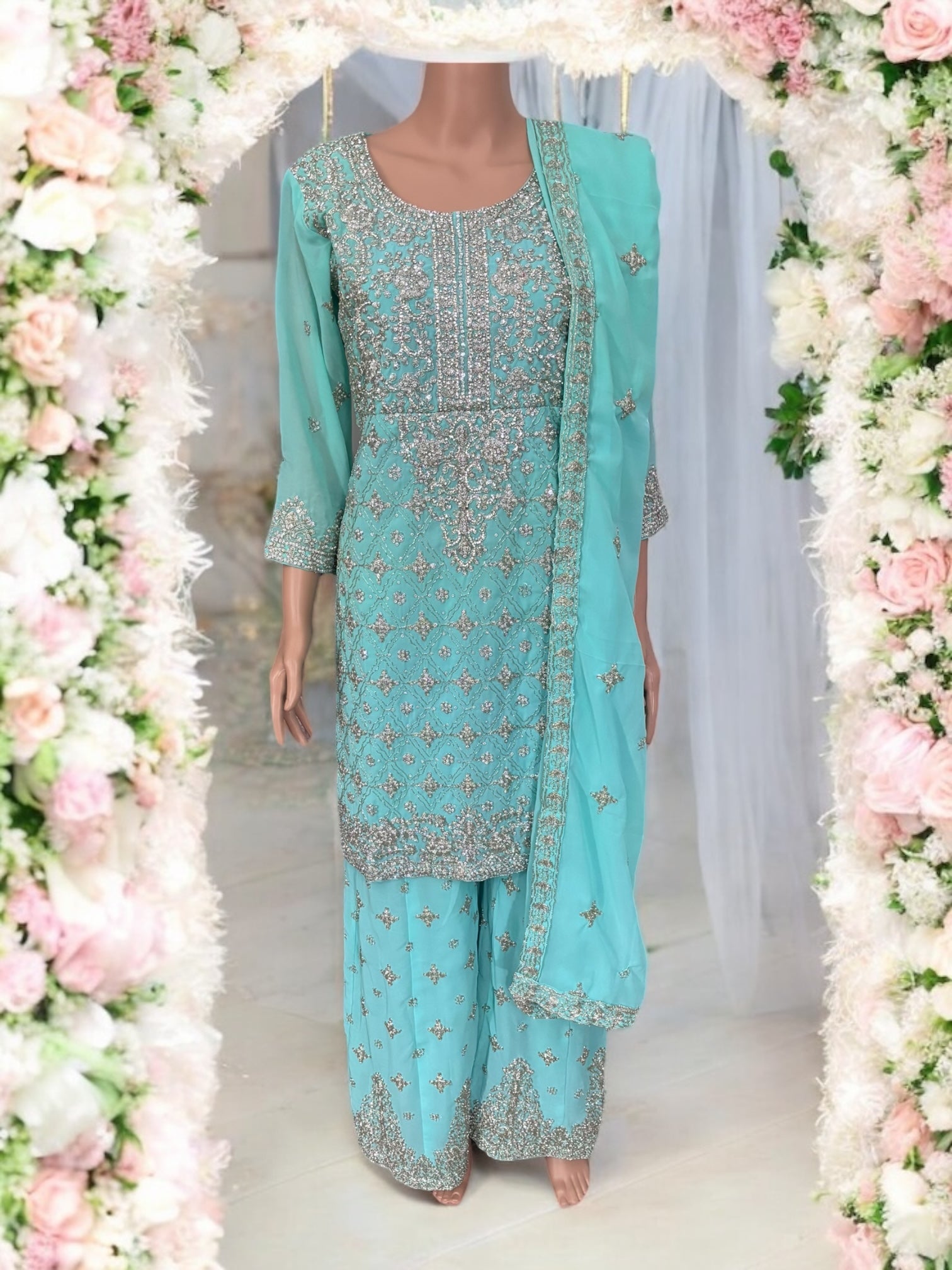 Traditional designer Sharara Salwar Kameez suit by Saree Ghor Charlotte, featuring intricate ethnic embroidery and vibrant fabric details.