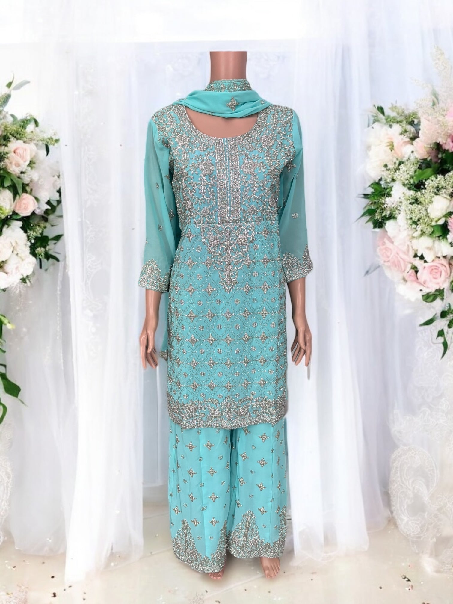 Traditional designer Sharara Salwar Kameez suit by Saree Ghor Charlotte, featuring intricate ethnic embroidery and vibrant fabric.