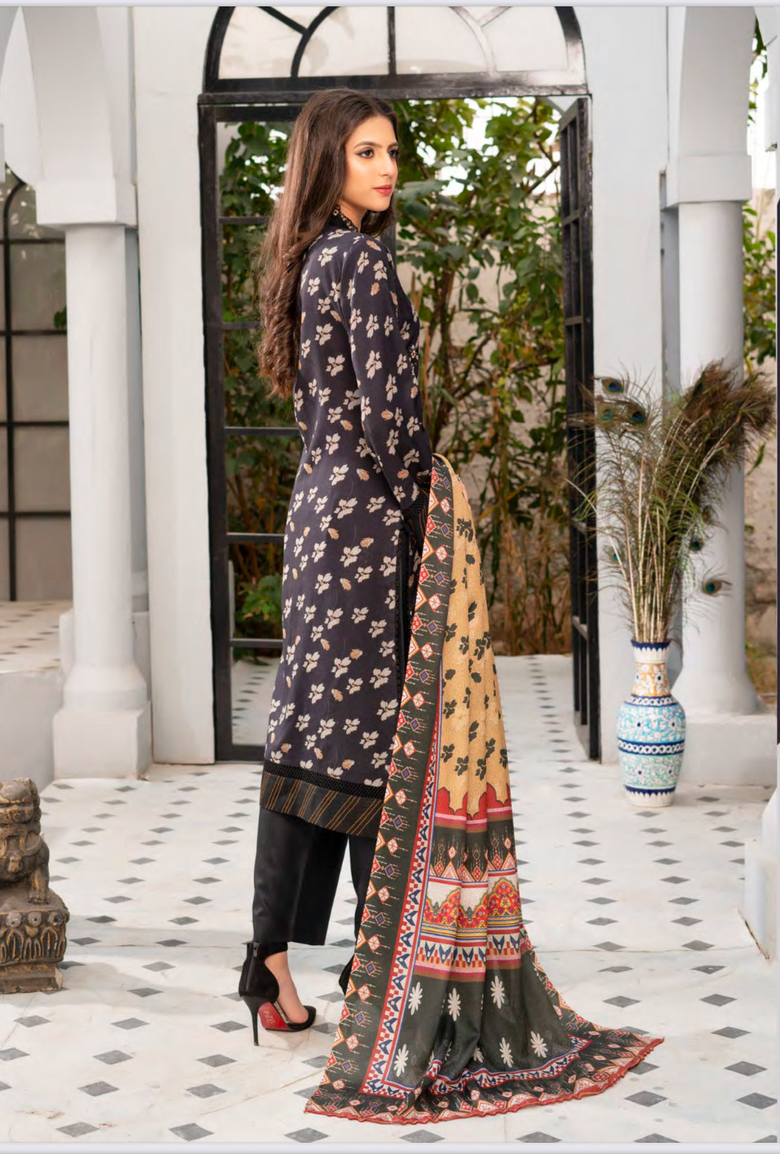 Traditional Pakistani Salwar Kameez by Saree Ghor Charlotte, ethnic women's wear with intricate embroidery and vibrant fabric.