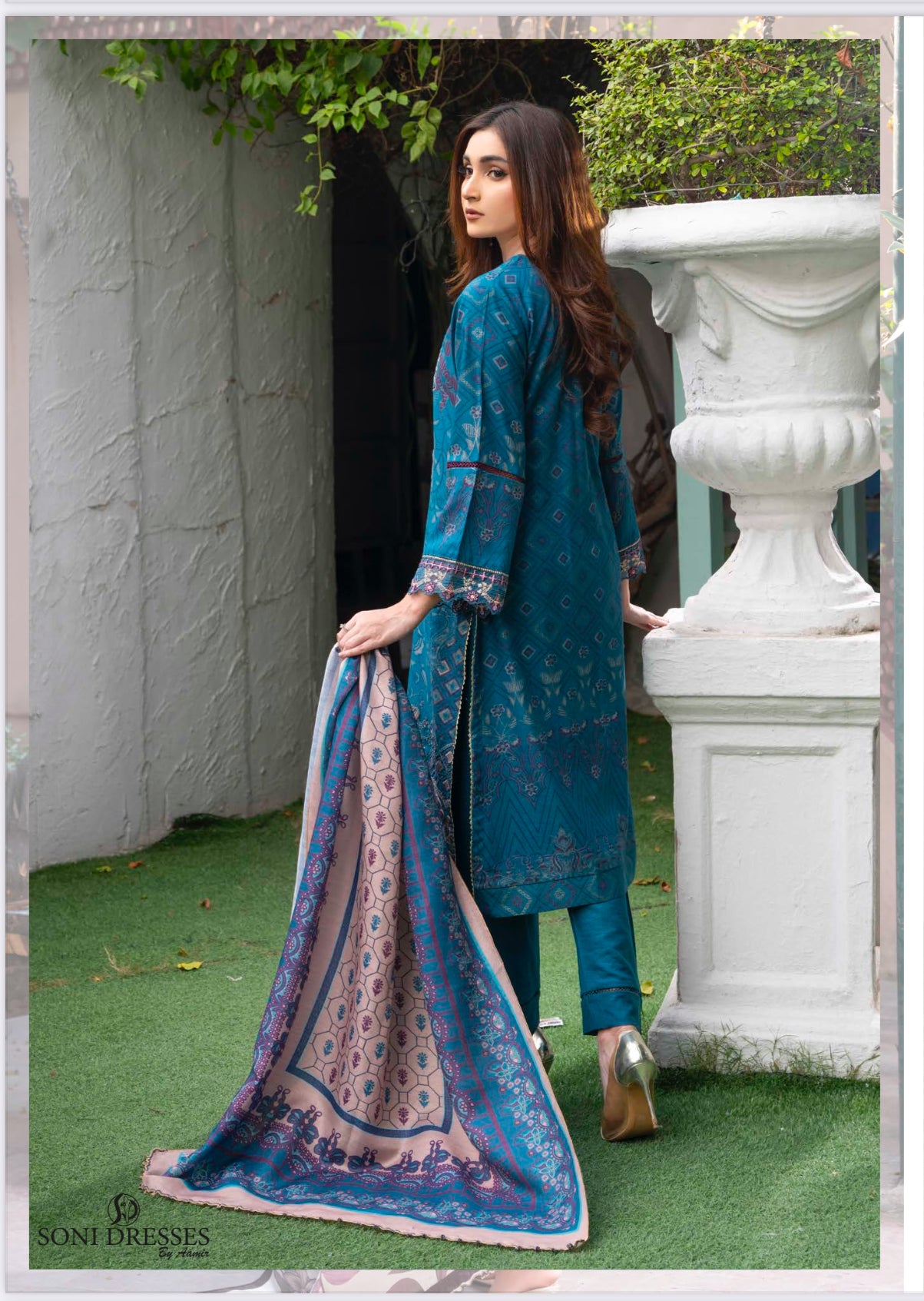 Traditional Pakistani Salwar Kameez by Saree Ghor Charlotte, ethnic women's wear with intricate embroidery and vibrant fabric.