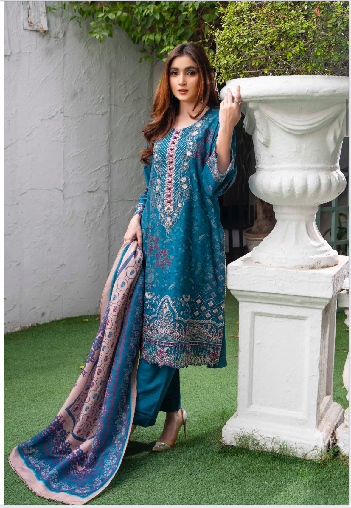 Traditional Pakistani Salwar Kameez by Saree Ghor Charlotte, colorful ethnic wear for women with intricate embroidery and vibrant fabric.
