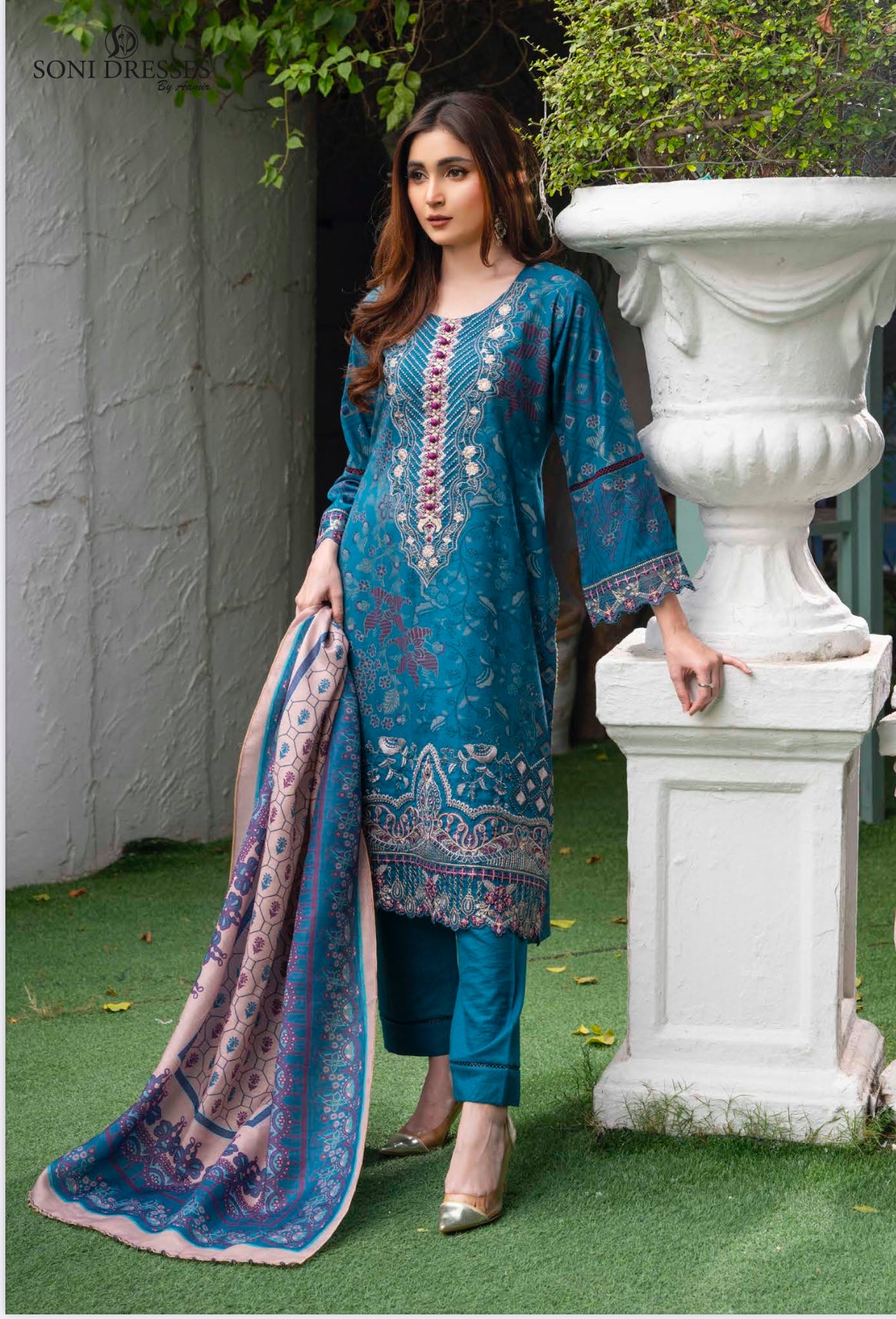 Traditional Pakistani Salwar Kameez by Saree Ghor Charlotte featuring intricate embroidery and vibrant colors for women.