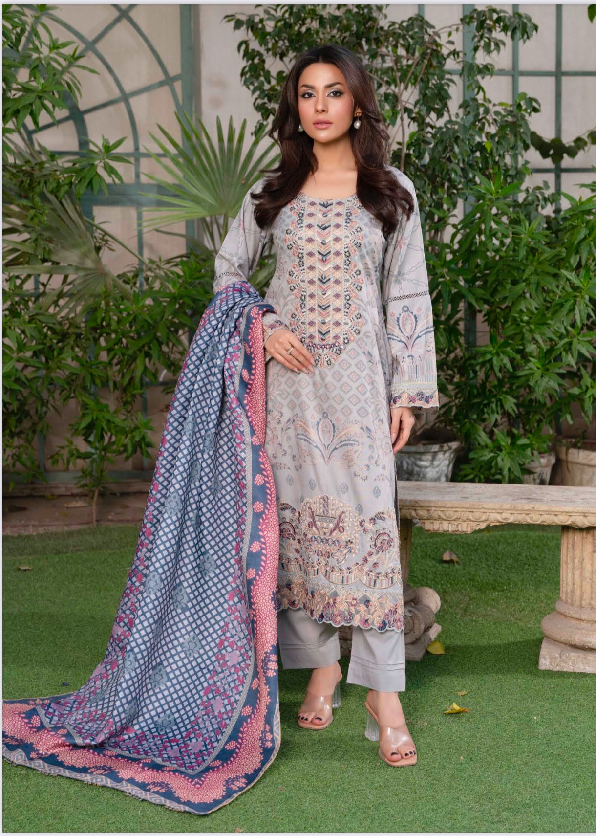Traditional Pakistani Salwar Kameez by Saree Ghor Charlotte, featuring vibrant ethnic wear for women with intricate patterns and colorful fabric.