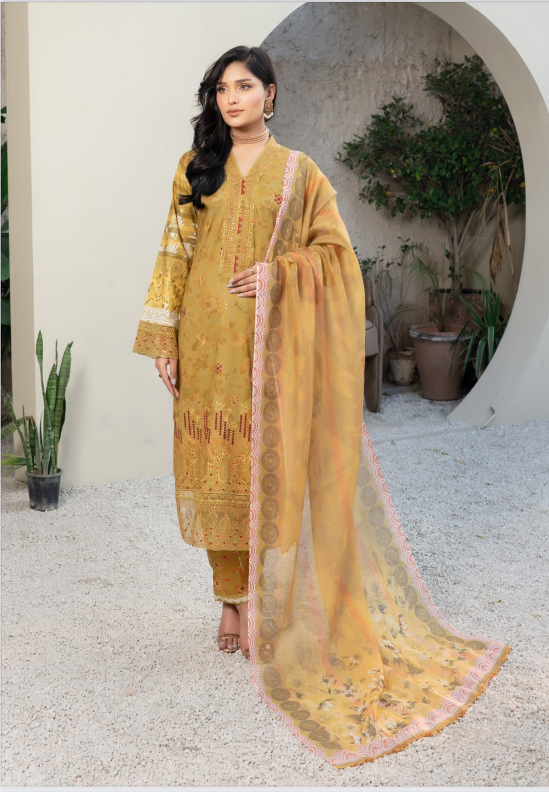 Traditional Pakistani Salwar Kameez by Saree Ghor Charlotte featuring intricate embroidery and vibrant fabric for women.
