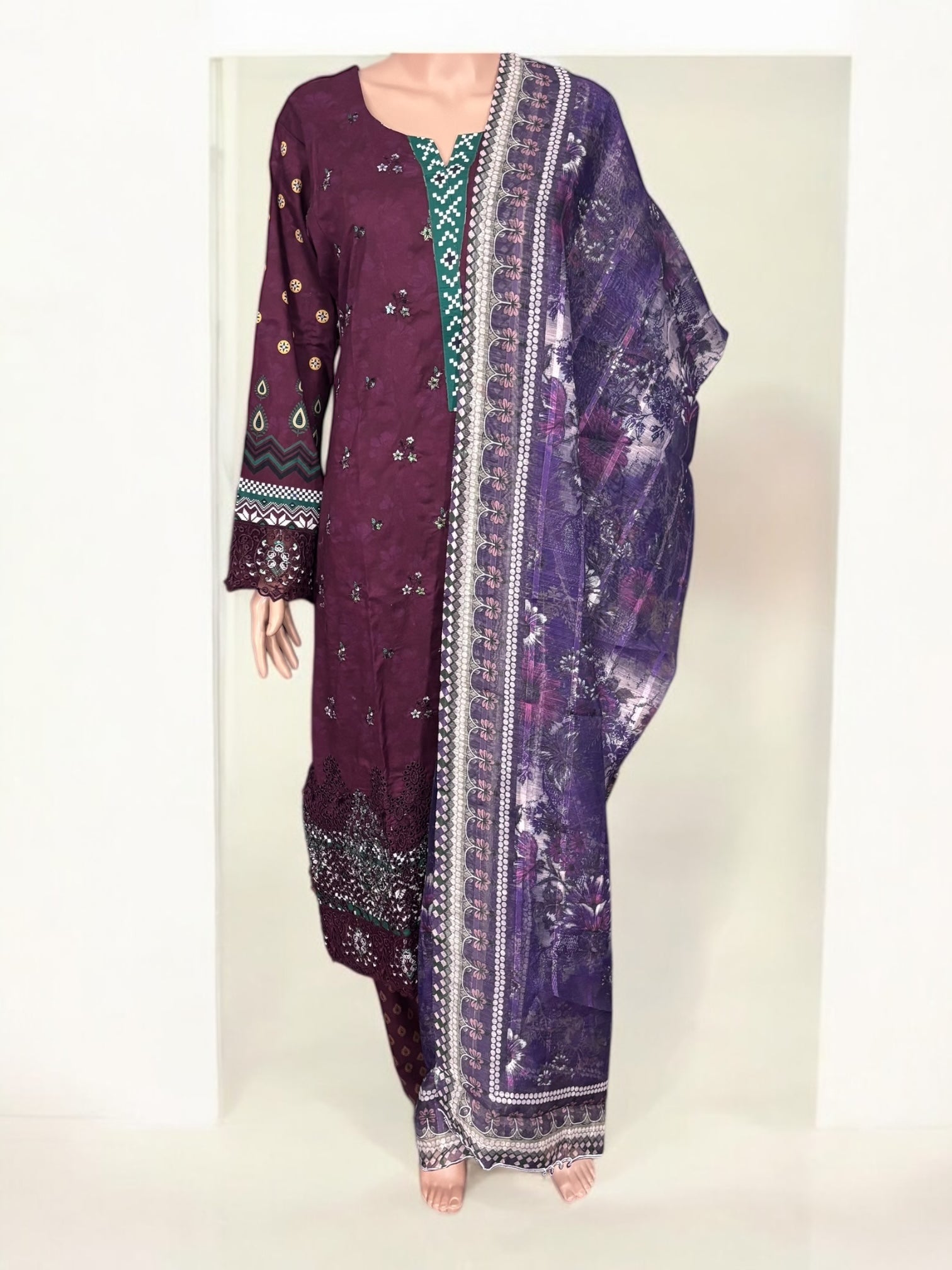 Traditional Pakistani Salwar Kameez by Saree Ghor Charlotte, featuring vibrant fabric and intricate ethnic embroidery for women.