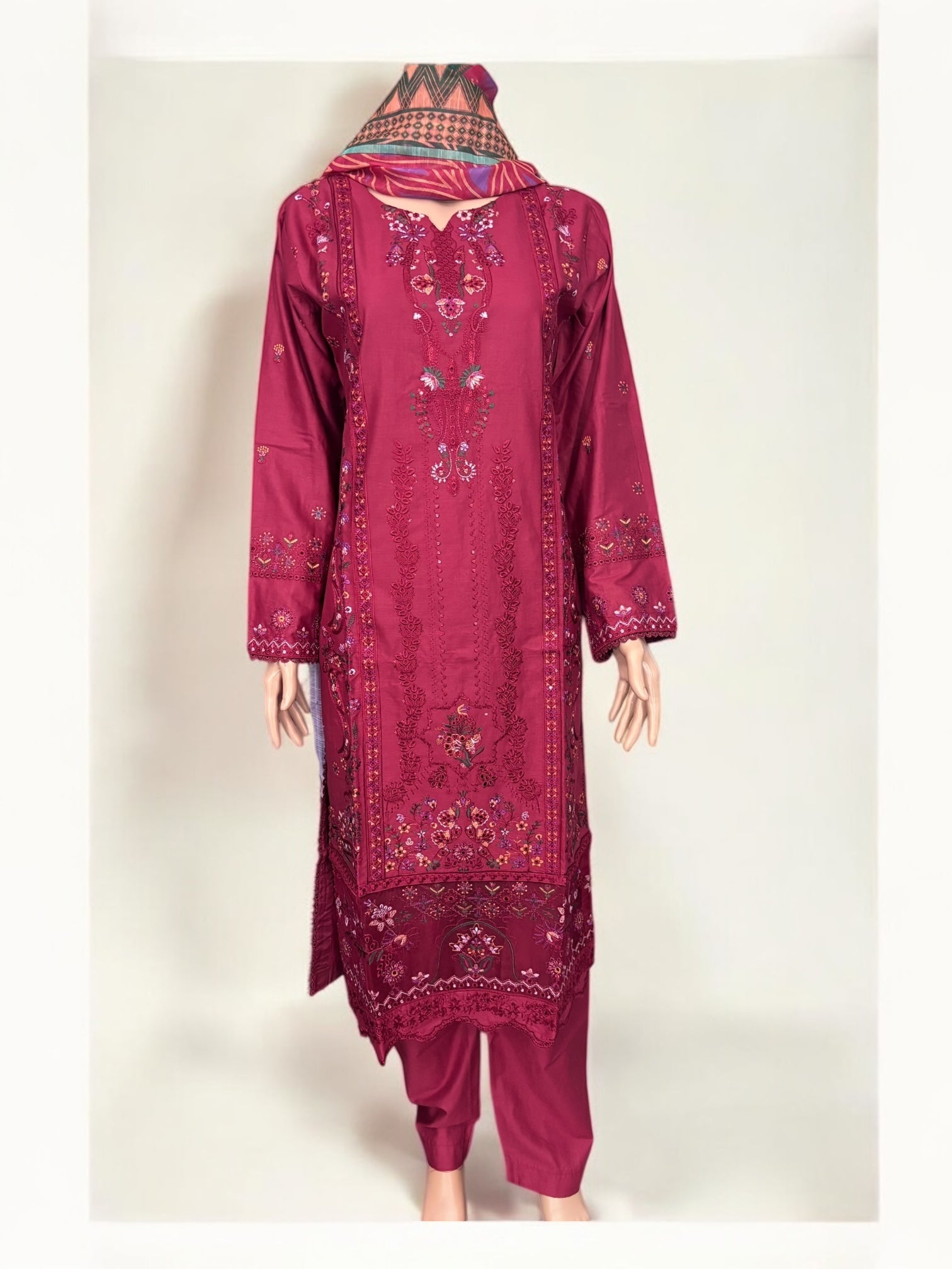 Traditional Pakistani Salwar Kameez by Saree Ghor Charlotte showing intricate embroidery and vibrant fabric for women’s ethnic wear.