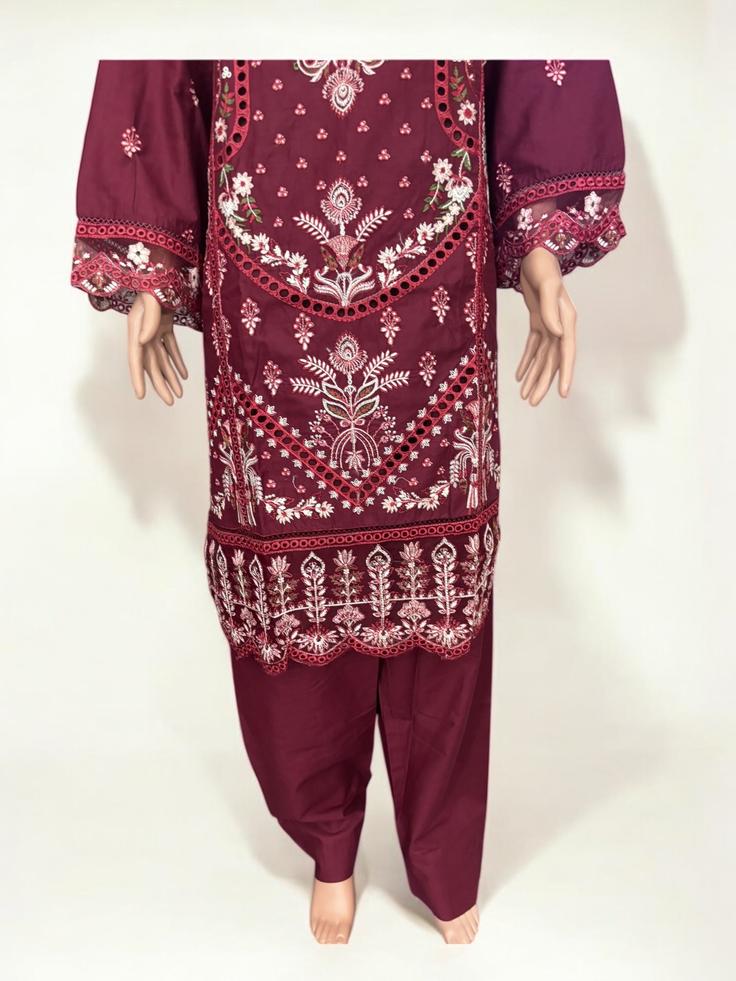 Traditional Pakistani Salwar Kameez by Saree Ghor Charlotte featuring vibrant fabric and intricate embroidery for women.