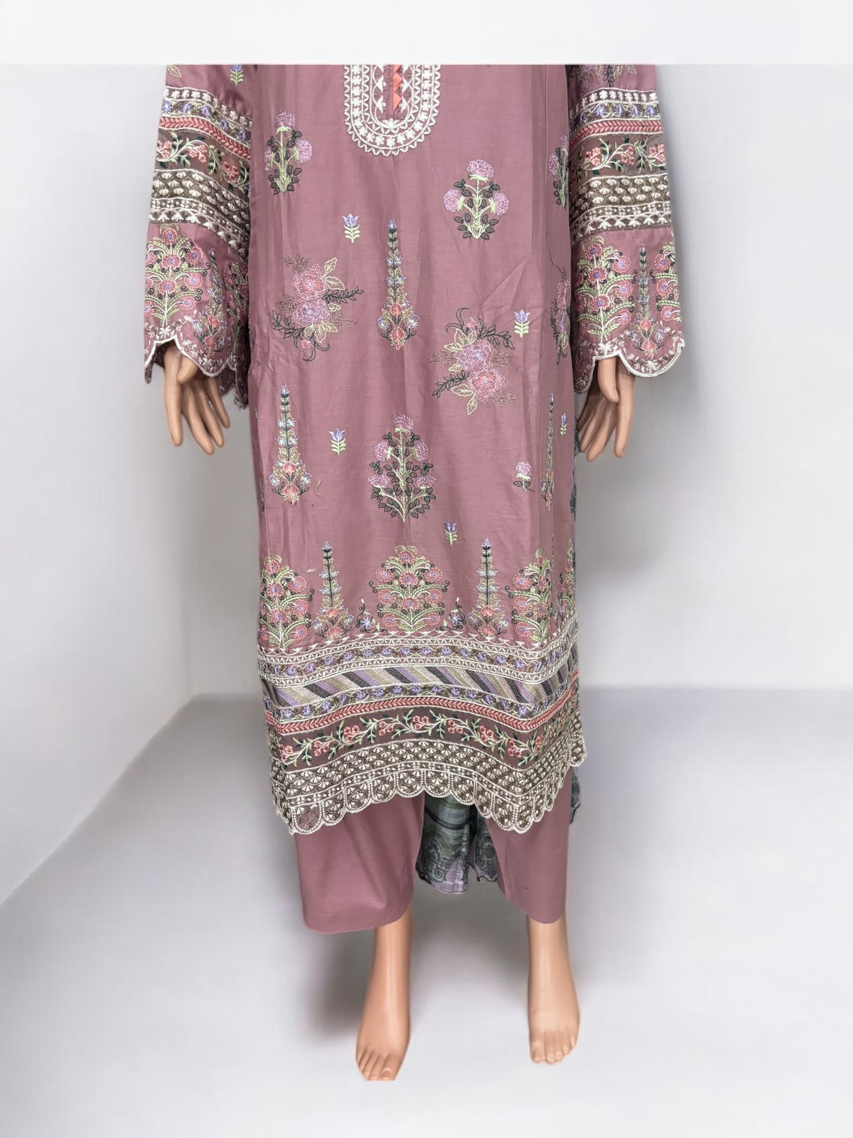 Traditional Pakistani Salwar Kameez by Saree Ghor Charlotte, vibrant ethnic wear for women featuring intricate embroidery and colorful fabric.