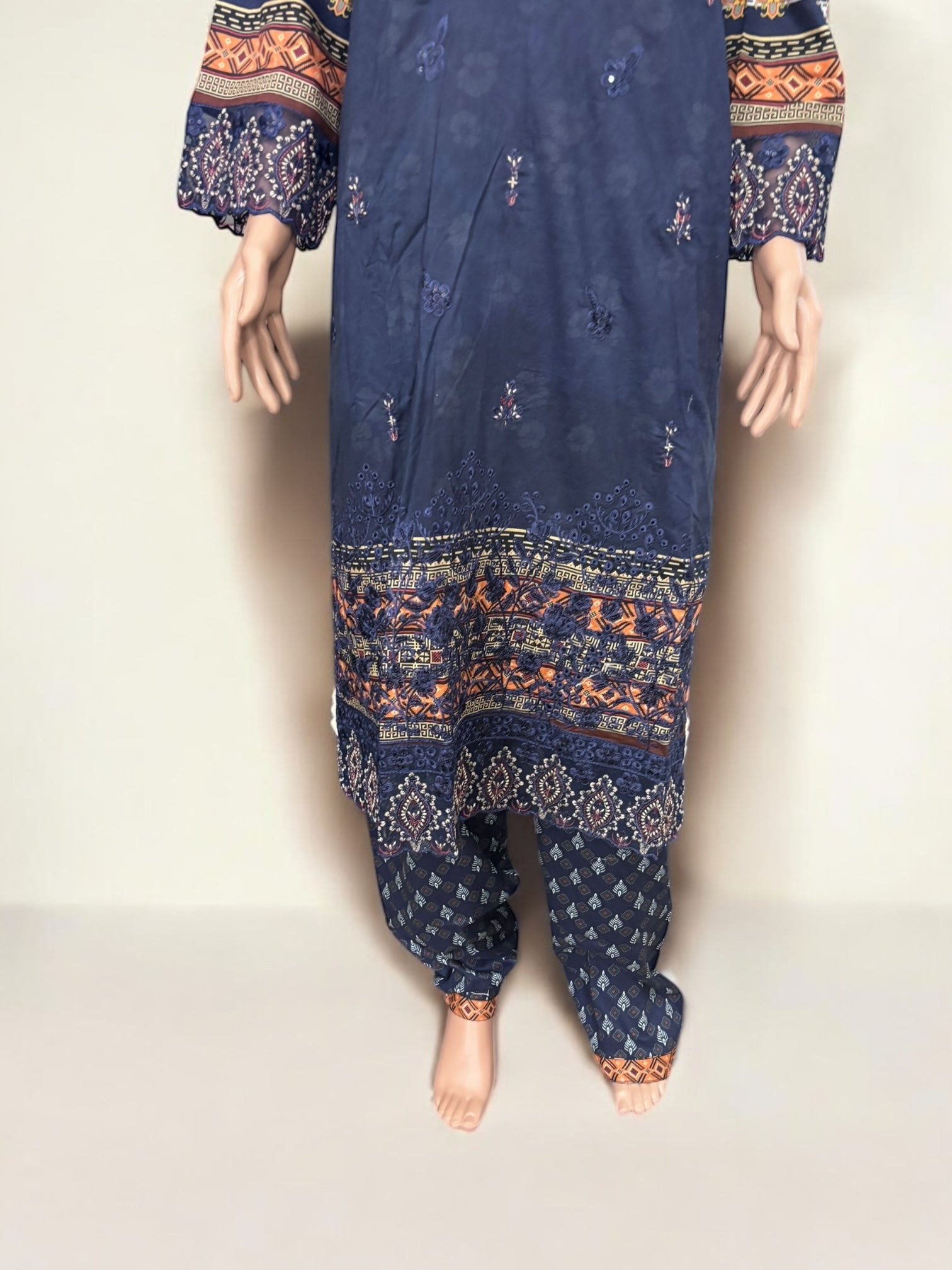 Traditional Pakistani Salwar Kameez by Saree Ghor Charlotte, elegant ethnic wear for women with intricate embroidery and vibrant fabric.