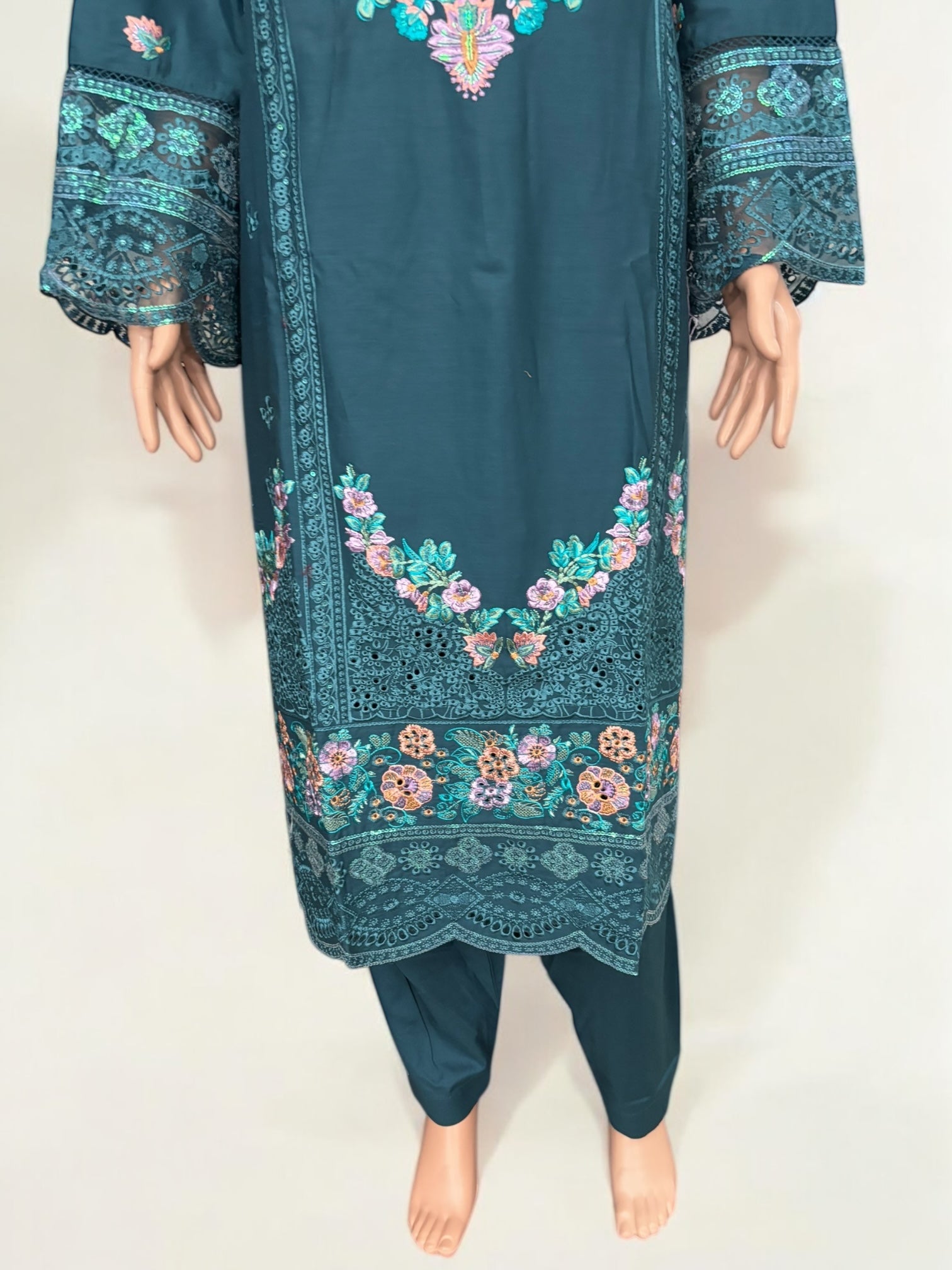 Traditional Pakistani Salwar Kameez by Saree Ghor Charlotte, ethnic women's wear with vibrant fabric and intricate embroidery.