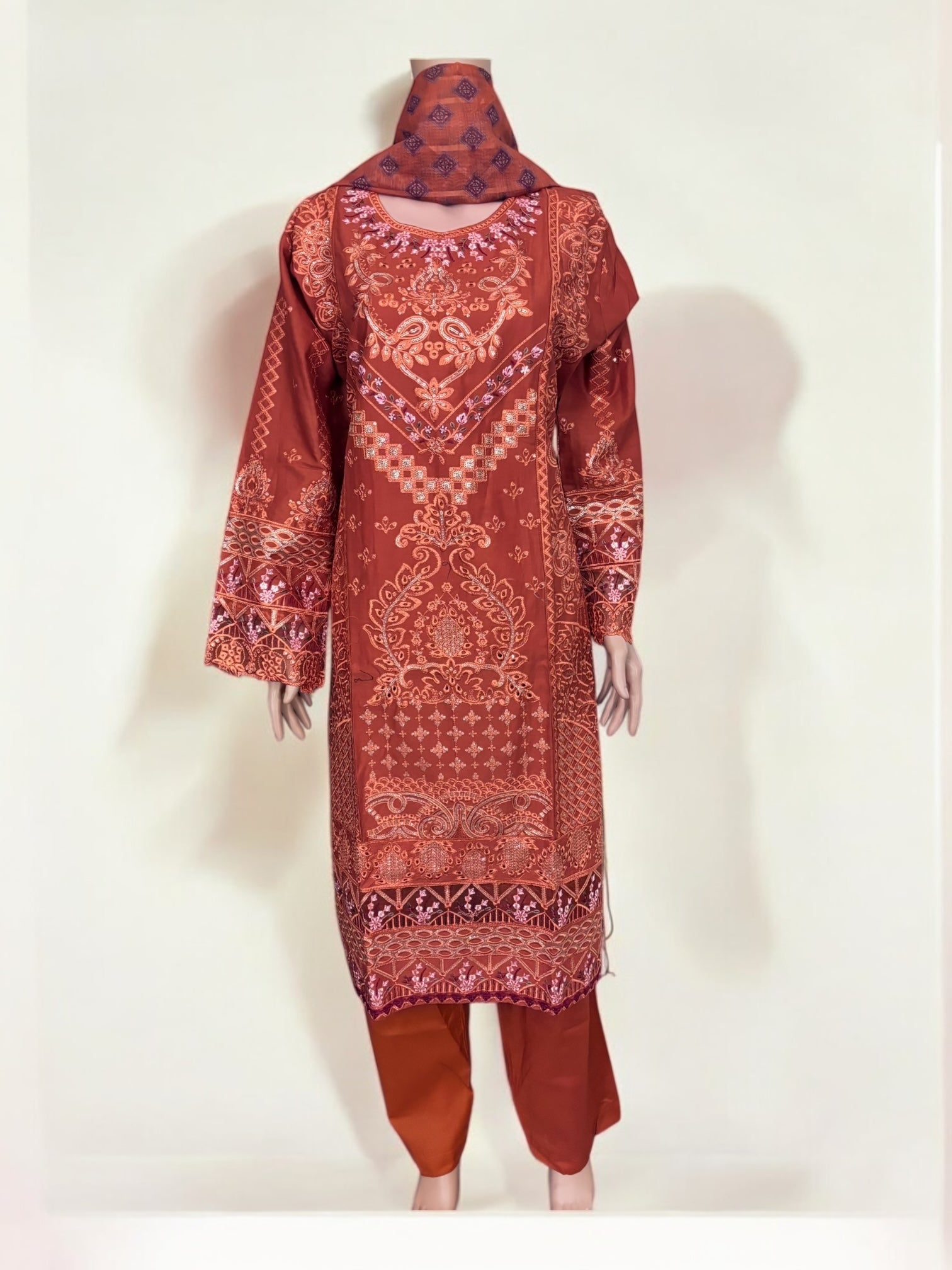 Traditional Pakistani Salwar Kameez by Saree Ghor Charlotte, ethnic wear for women with vibrant fabric and intricate embroidery.
