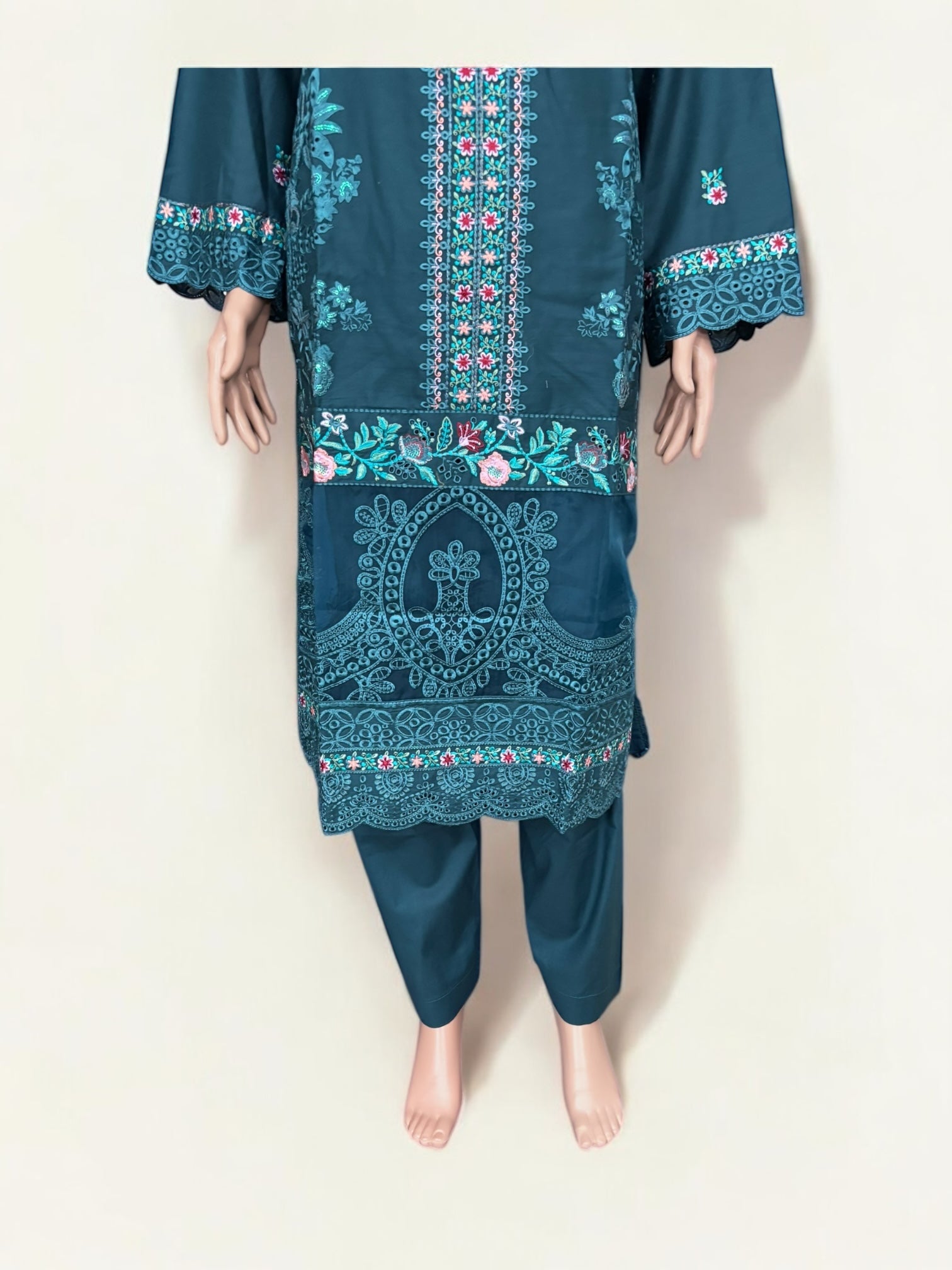 Traditional Pakistani Salwar Kameez by Saree Ghor Charlotte, showcasing vibrant ethnic wear for women with intricate embroidery and fabric details.