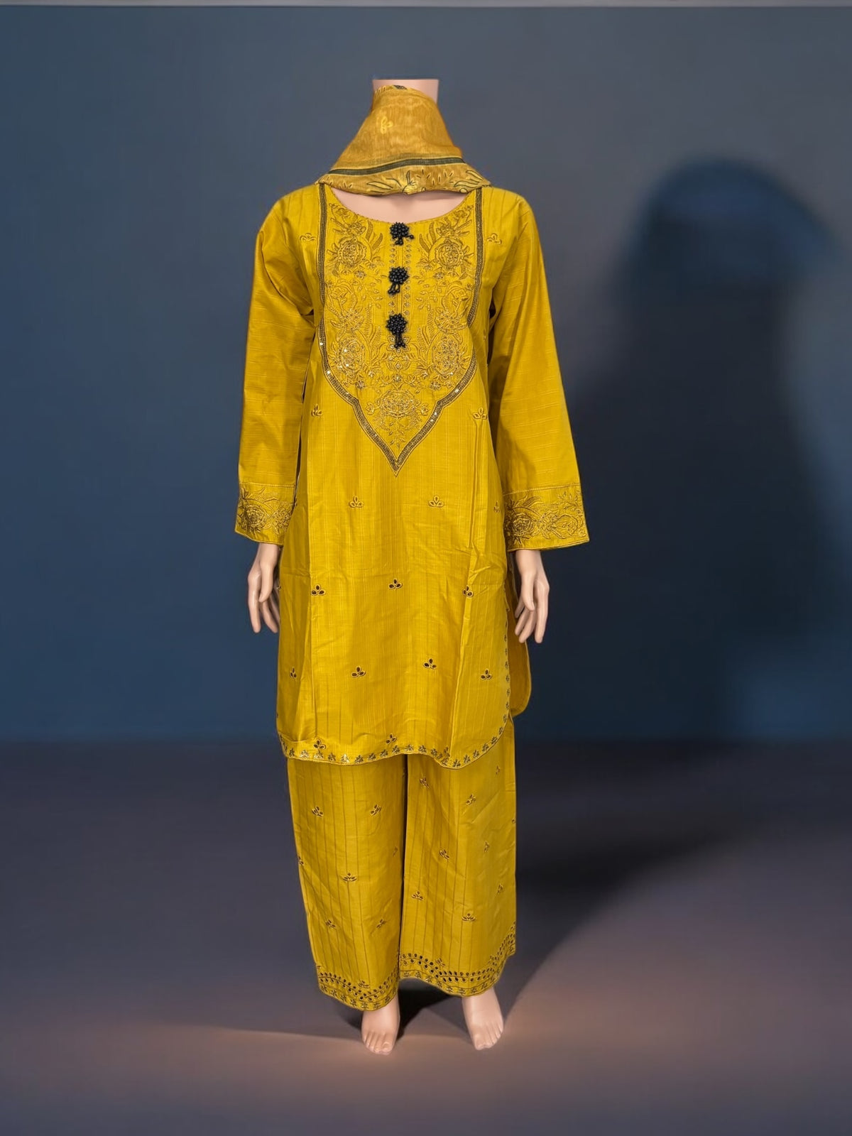 Traditional Pakistani Salwar Kameez by Saree Ghor Charlotte, ethnic women's wear with intricate embroidery and vibrant fabric.