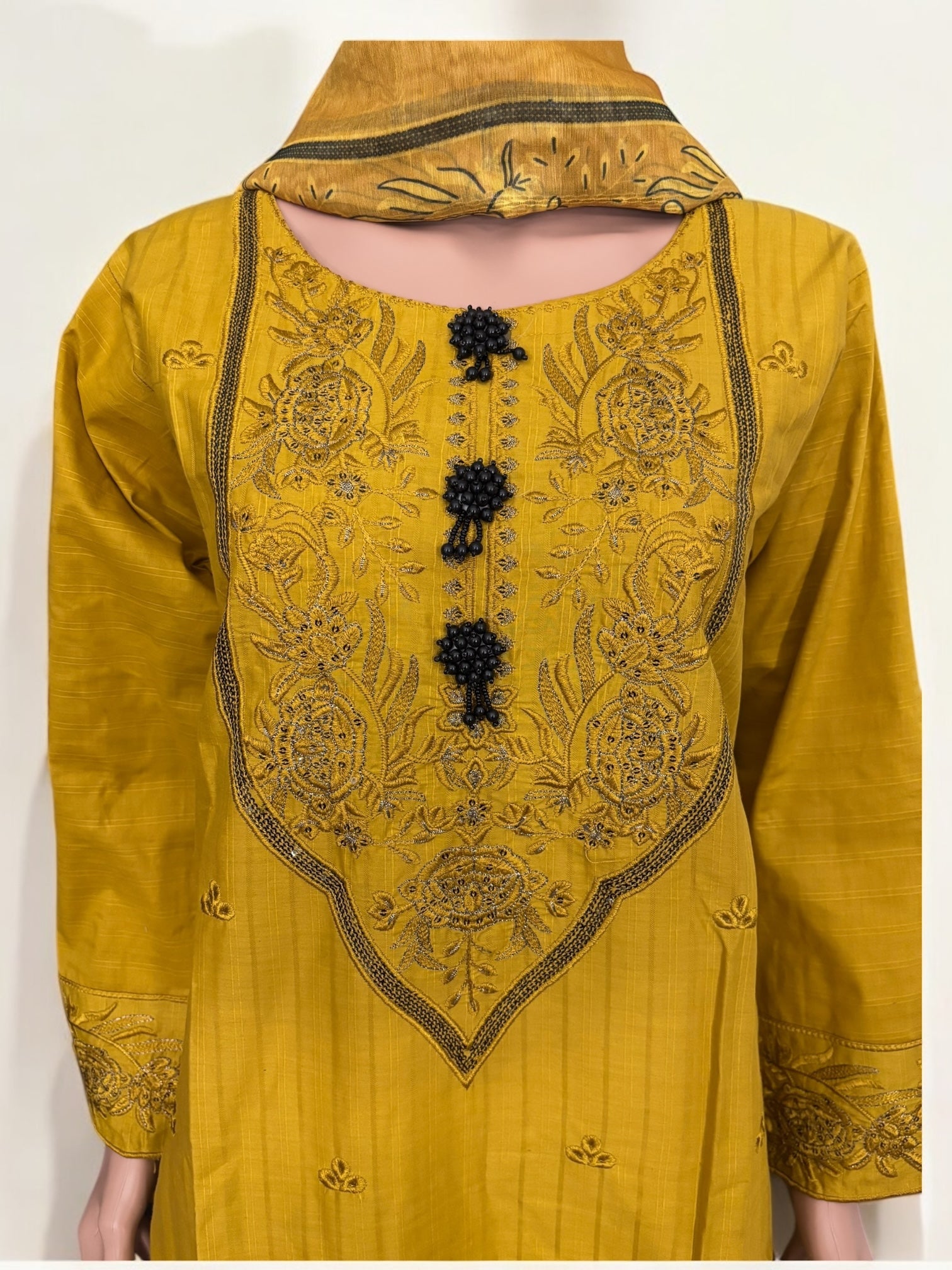 Traditional Pakistani Salwar Kameez by Saree Ghor Charlotte featuring intricate embroidery and vibrant ethnic wear for women.