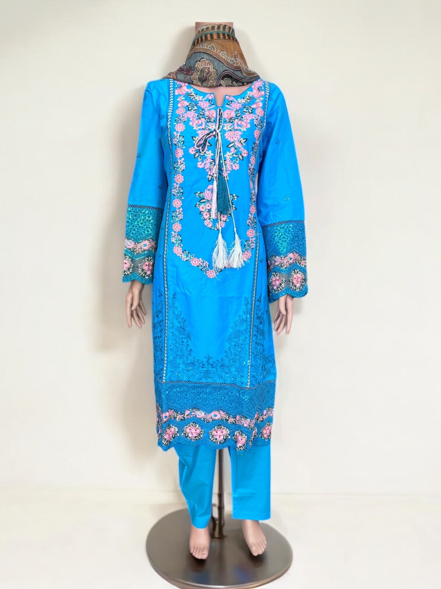 Traditional Pakistani Salwar Kameez by Saree Ghor Charlotte, women’s ethnic wear with vibrant fabric and intricate embroidery.