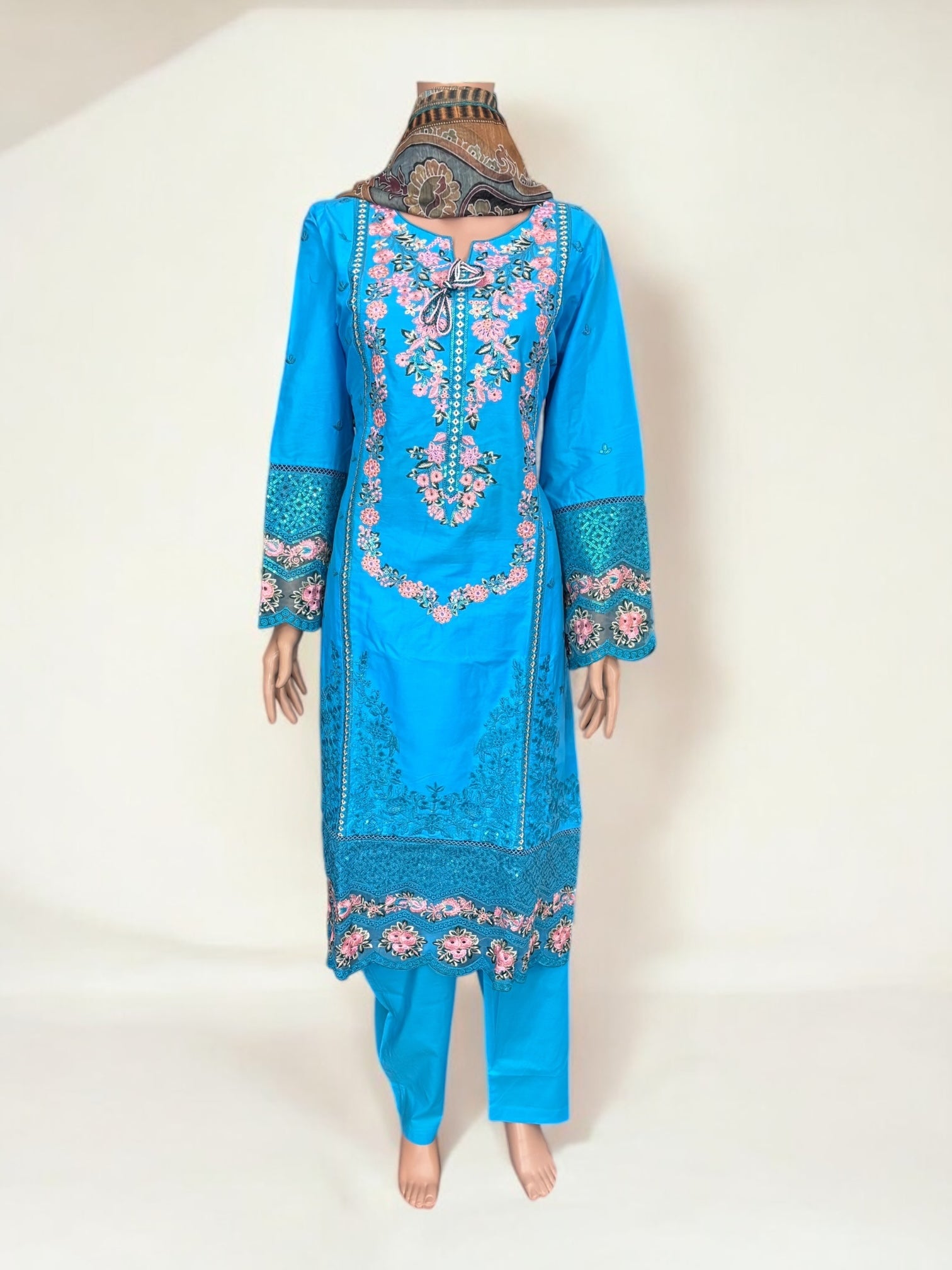 Traditional Pakistani Salwar Kameez by Saree Ghor Charlotte, featuring vibrant ethnic wear for women with intricate embroidery.