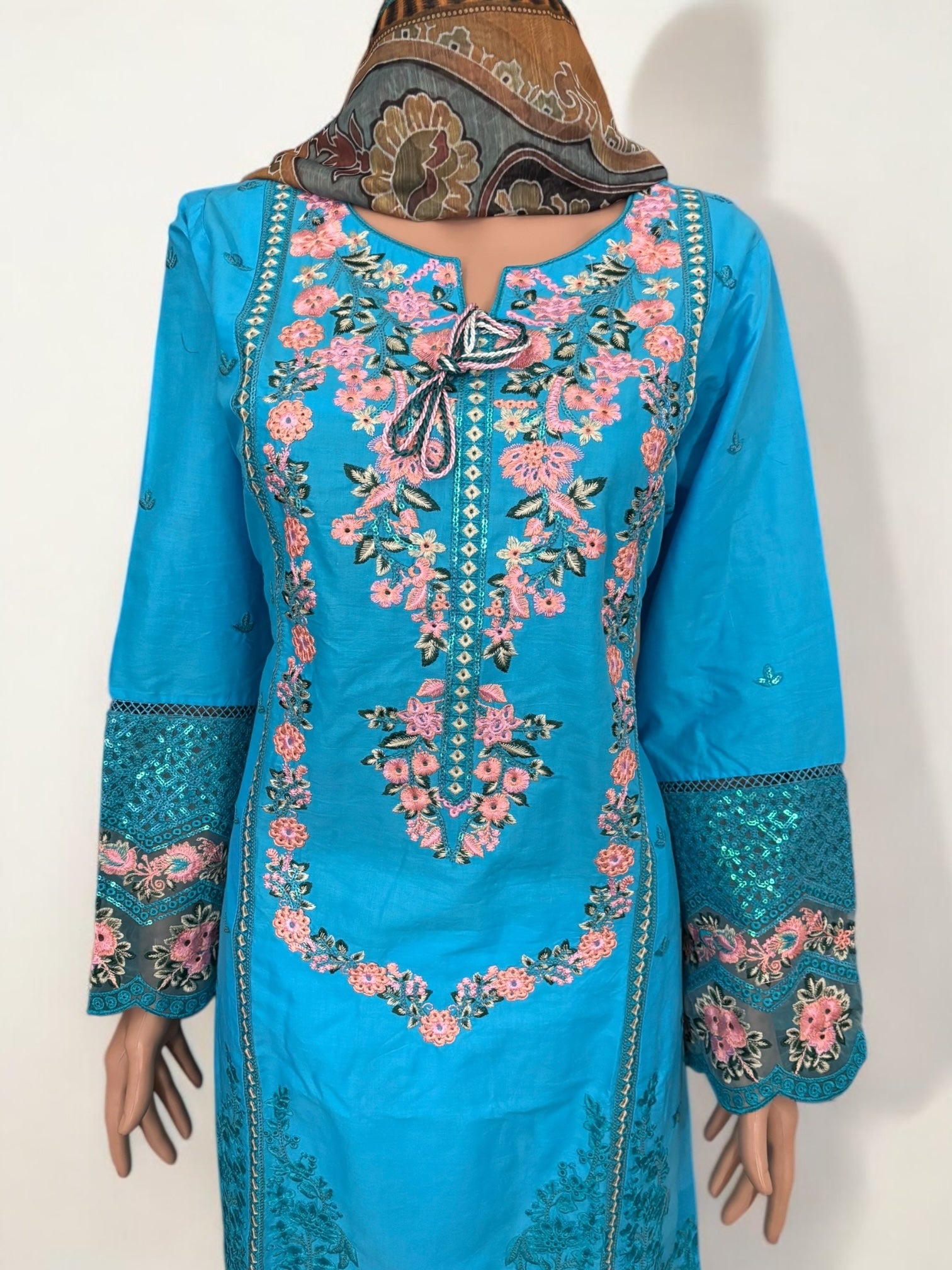 Traditional Pakistani Salwar Kameez by Saree Ghor Charlotte, showcasing vibrant ethnic wear for women with intricate embroidery.