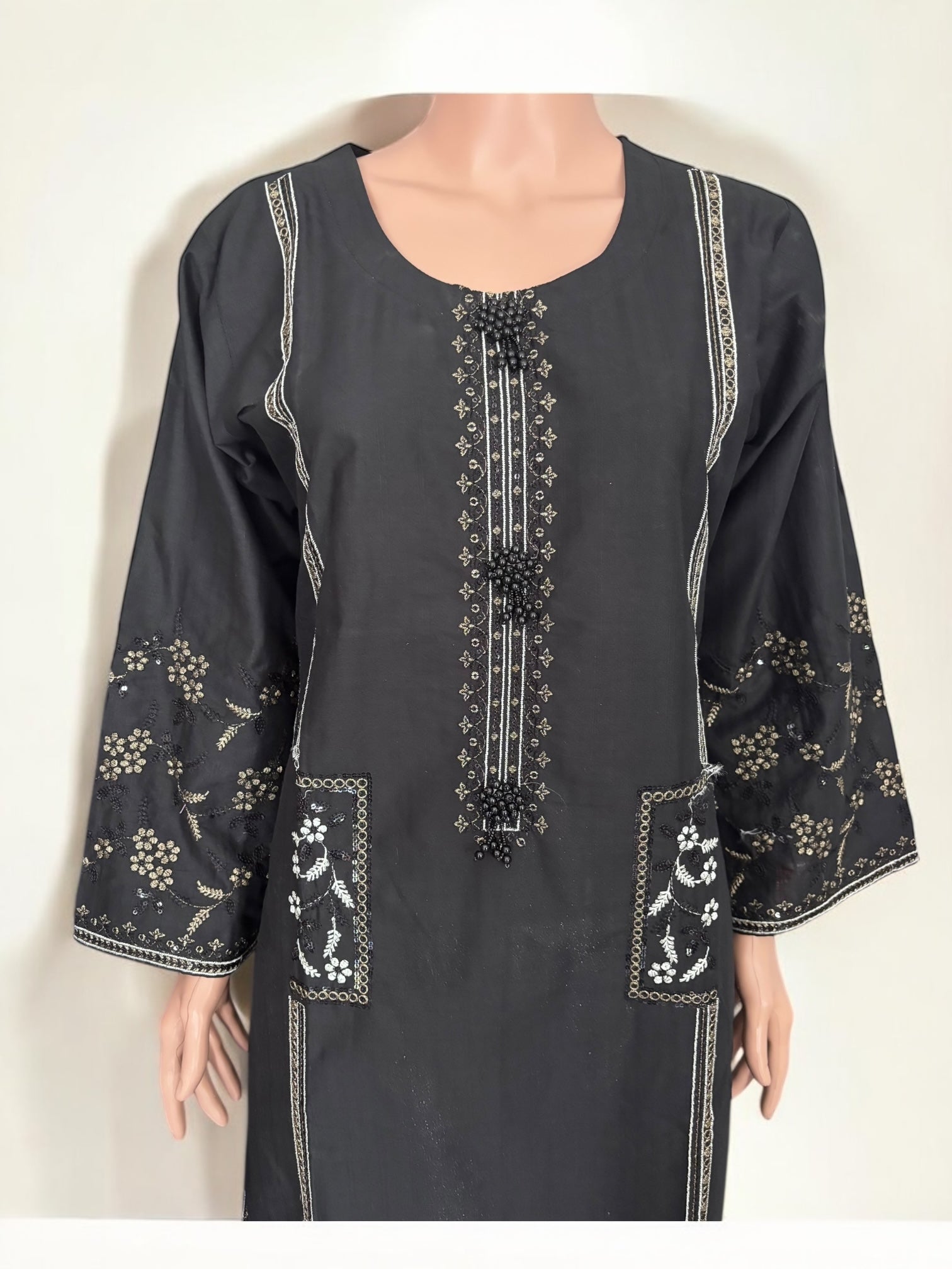 Traditional Pakistani Salwar Kameez by Saree Ghor Charlotte, showcasing intricate embroidery and vibrant ethnic wear for women.