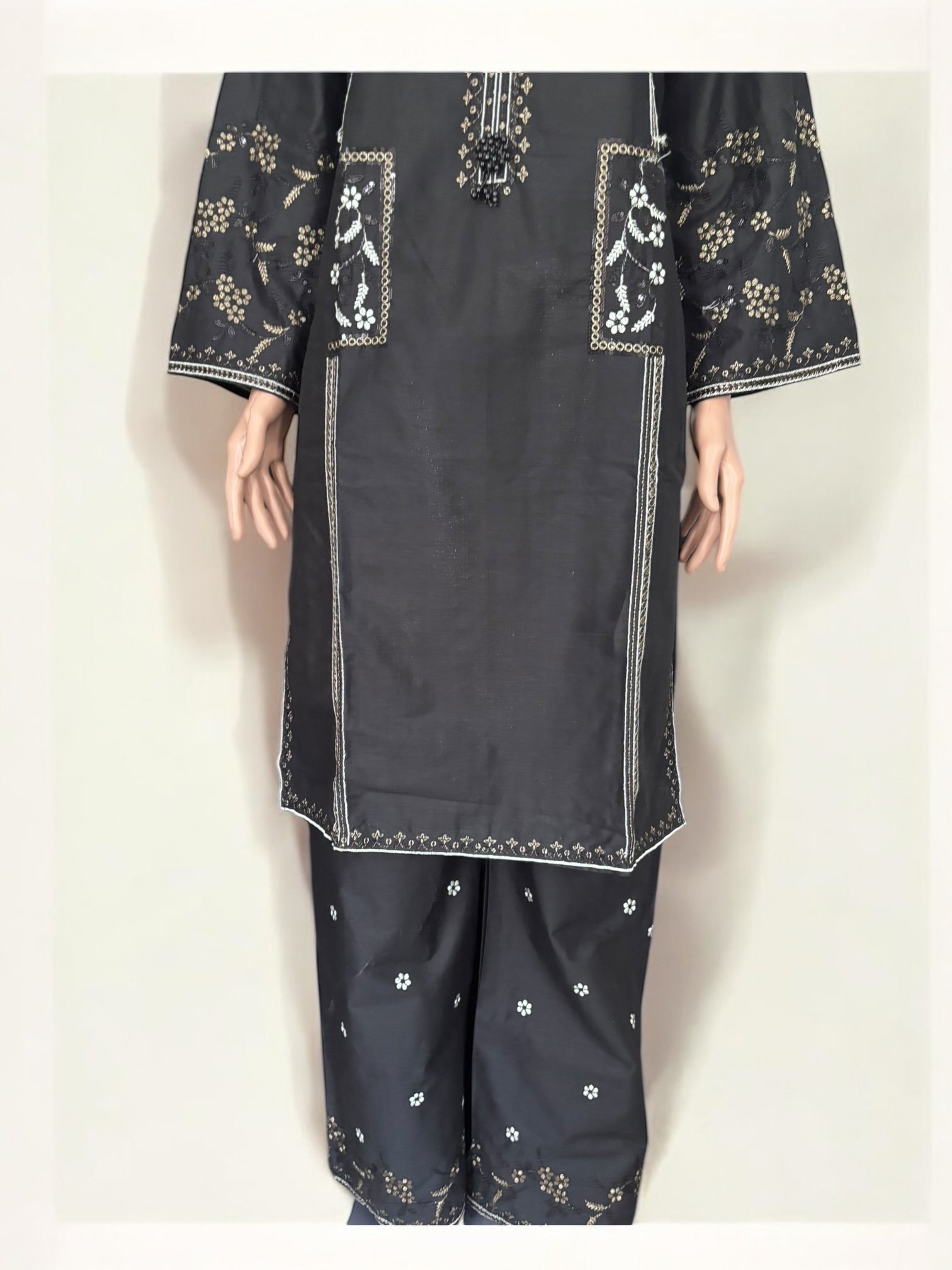 Traditional Pakistani Salwar Kameez by Saree Ghor Charlotte, elegant ethnic wear for women with intricate fabric and vibrant colors.