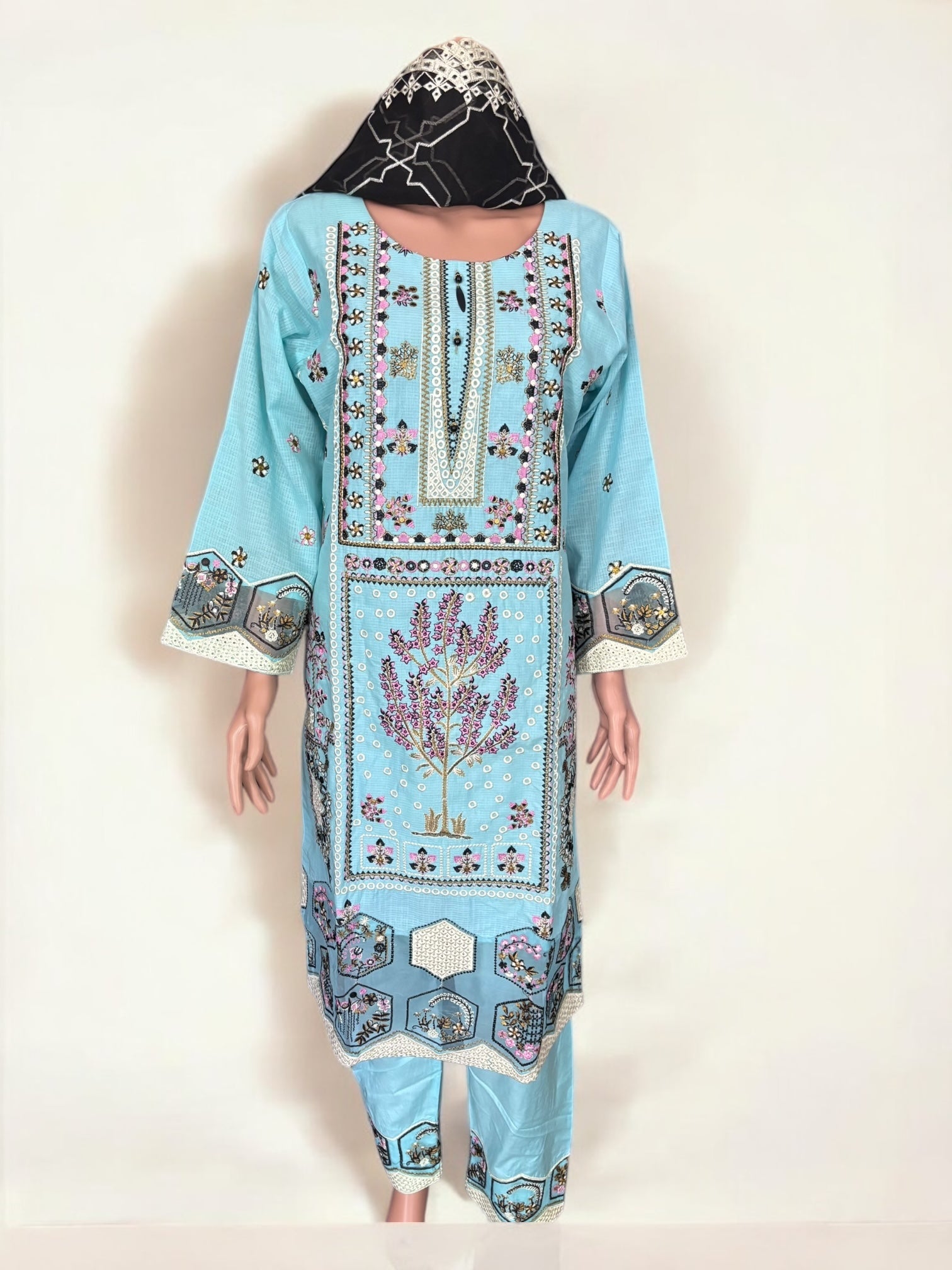 Traditional Pakistani Salwar Kameez by Saree Ghor Charlotte featuring intricate embroidery and vibrant fabric for women.