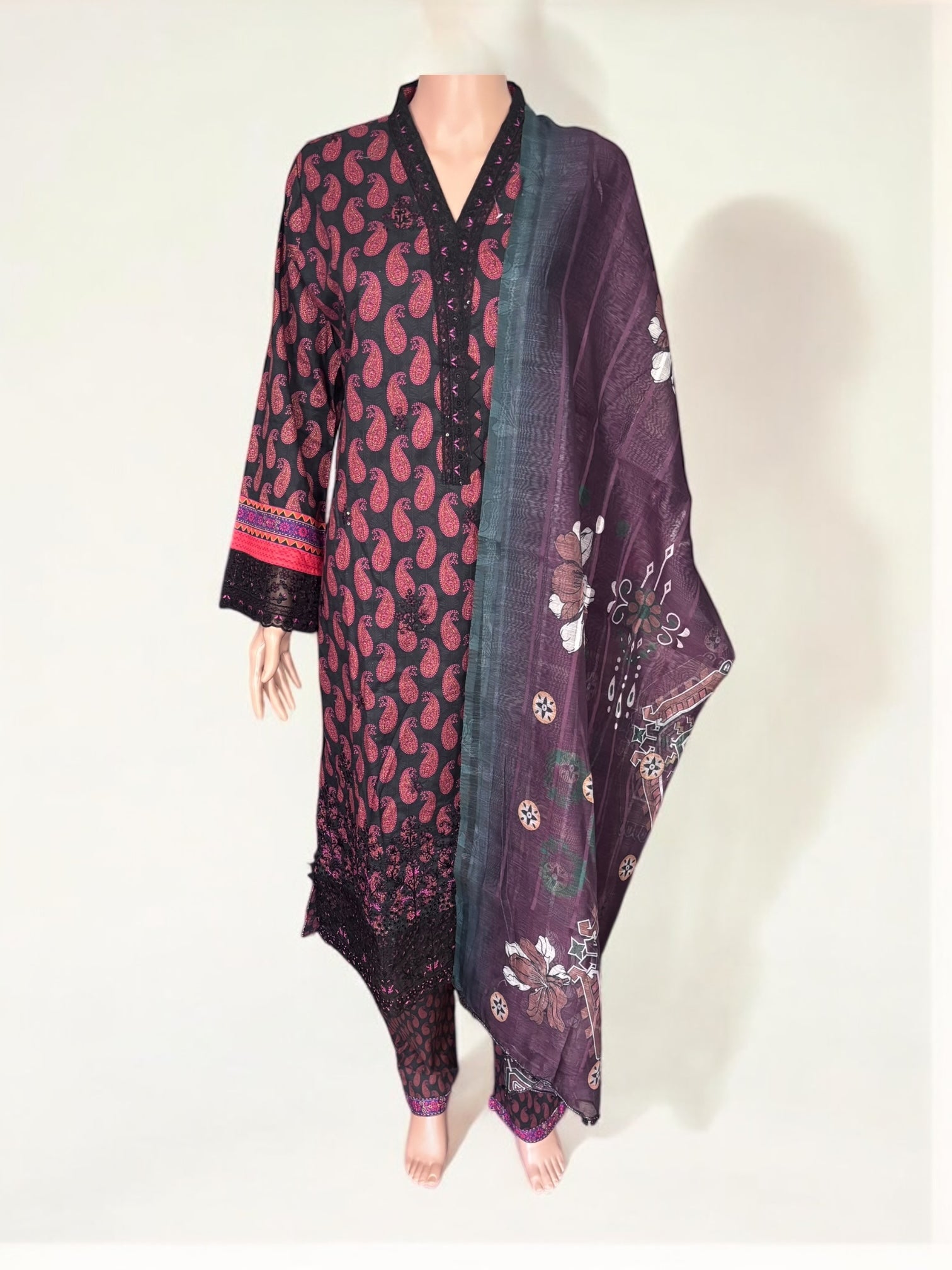 Traditional Pakistani Salwar Kameez by Saree Ghor Charlotte, elegant ethnic wear for women with intricate fabric details.