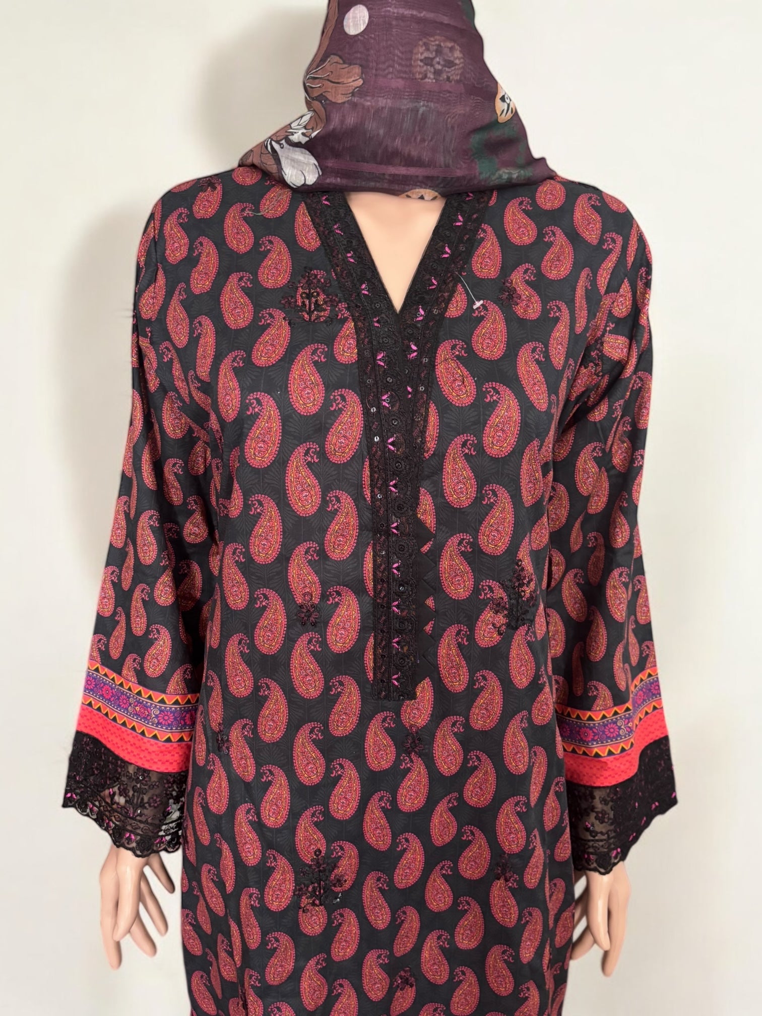 Traditional Pakistani Salwar Kameez by Saree Ghor Charlotte, showcasing vibrant ethnic wear with intricate patterns for women.