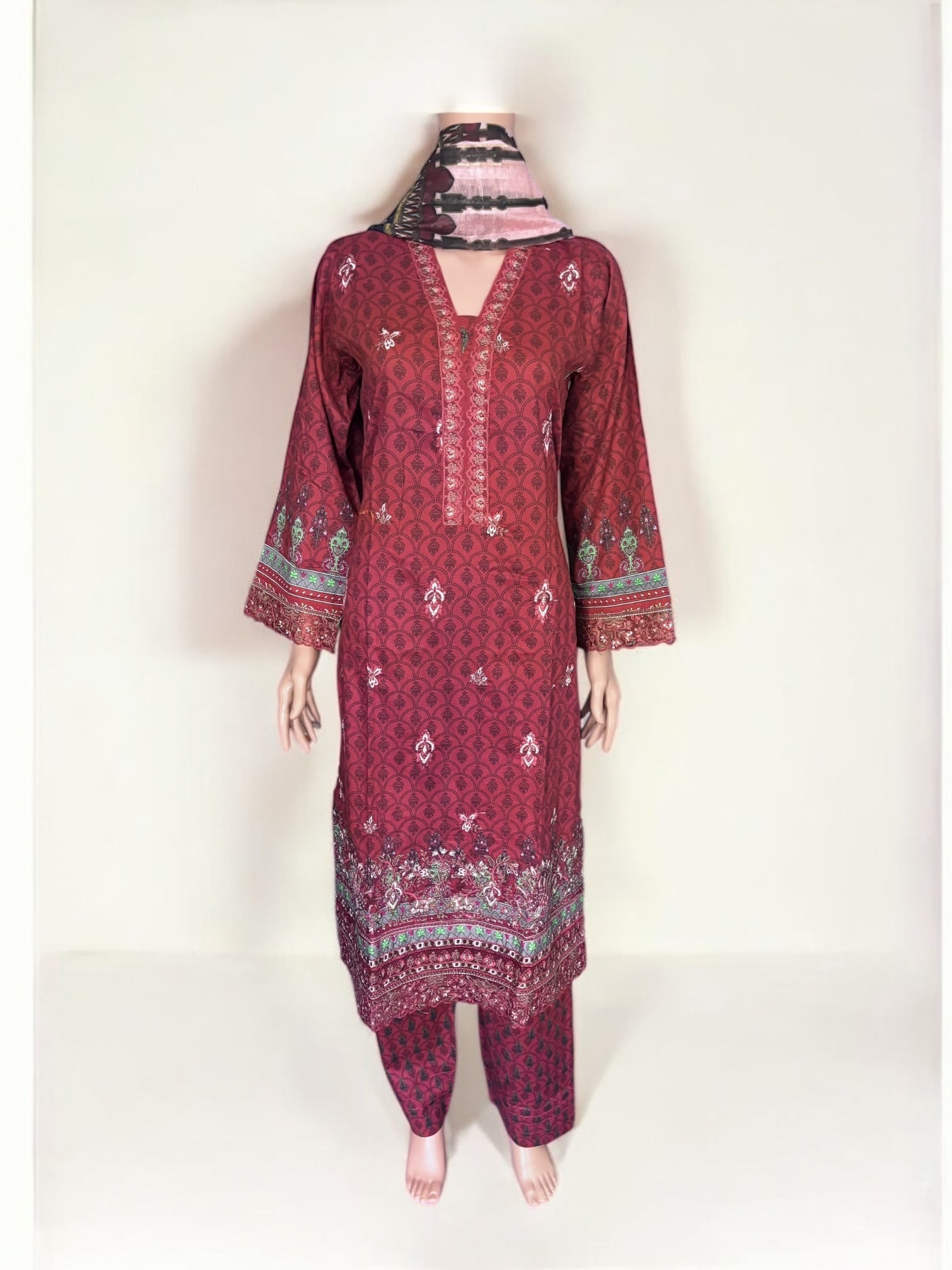 Traditional Pakistani Salwar Kameez by Saree Ghor Charlotte, showcasing intricate embroidery and vibrant ethnic wear for women.