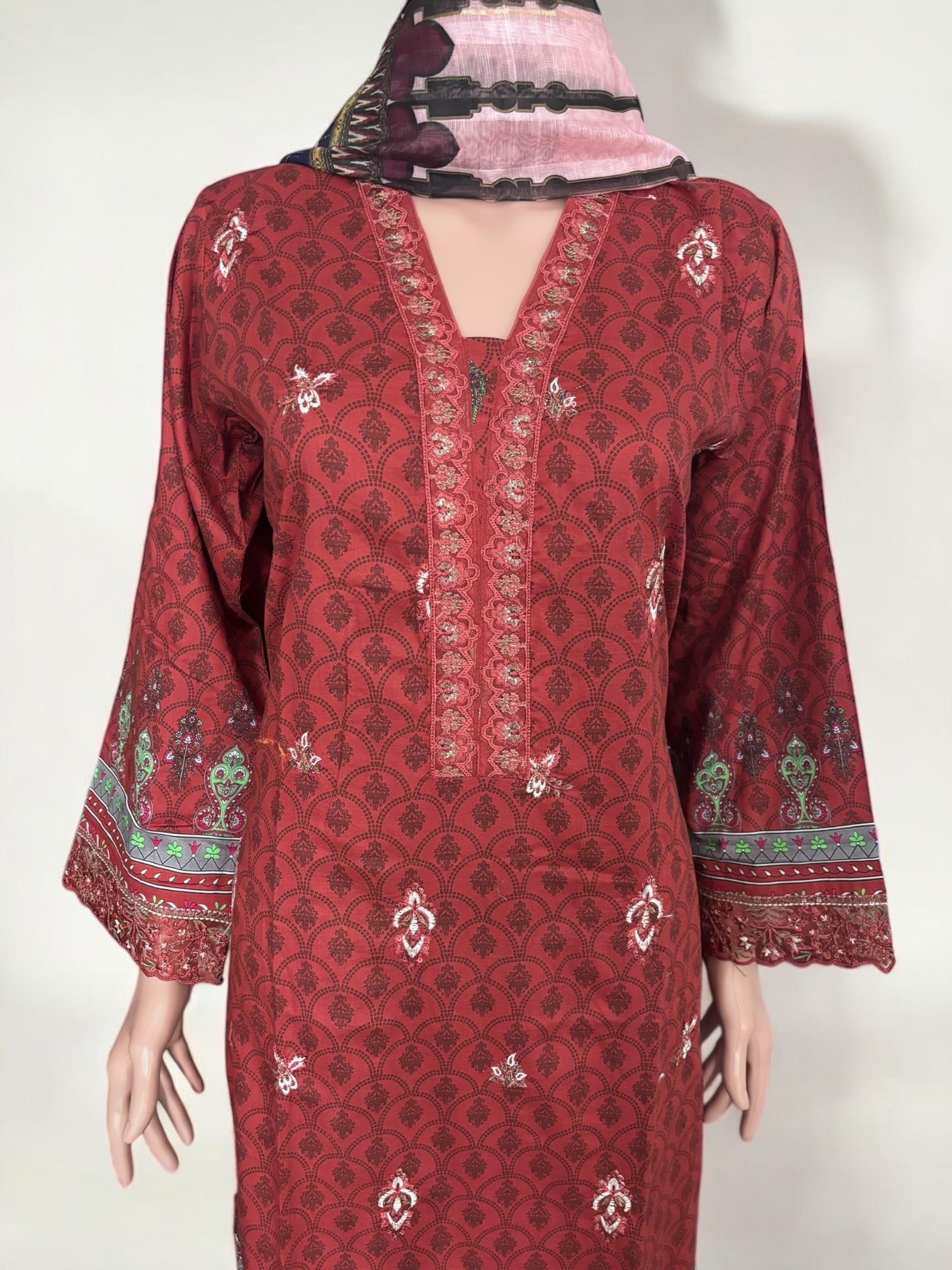 Traditional Pakistani Salwar Kameez by Saree Ghor Charlotte, vibrant ethnic wear for women featuring intricate embroidery and flowing fabric.