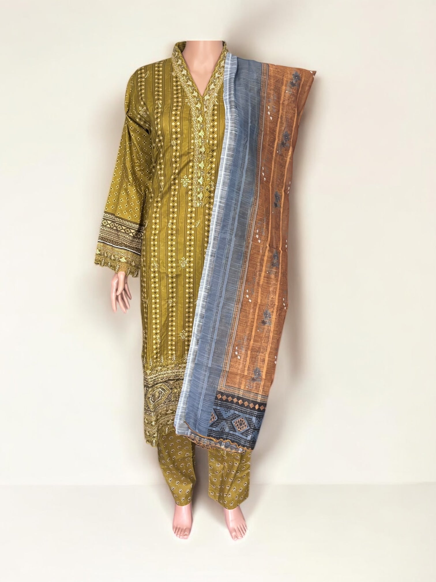 Traditional Pakistani Salwar Kameez by Saree Ghor Charlotte featuring intricate embroidery and vibrant ethnic wear for women.