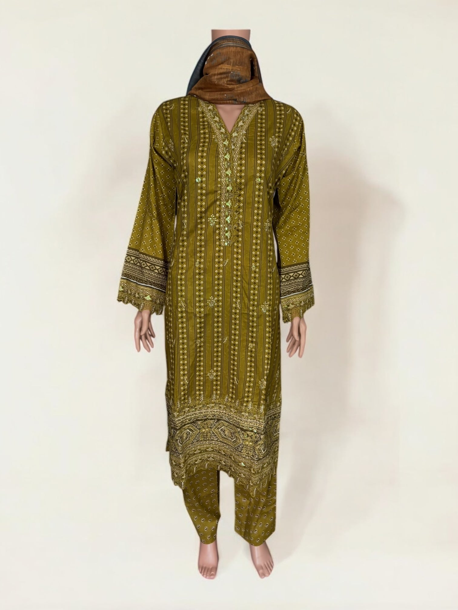 Traditional Pakistani Salwar Kameez by Saree Ghor Charlotte featuring intricate embroidery and vibrant colors for women's ethnic wear.
